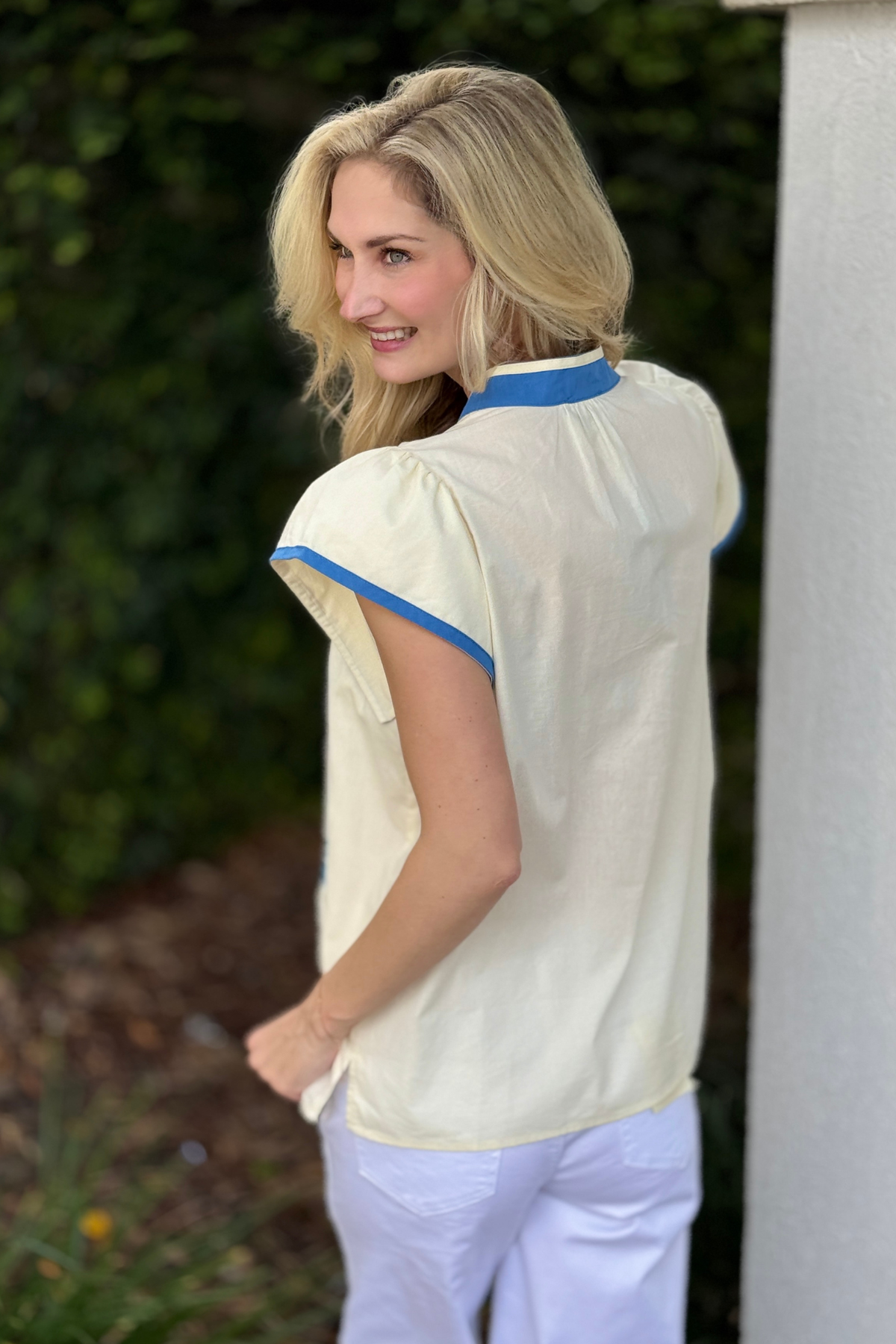 Spring embroidered ivory blouse styled with white pants