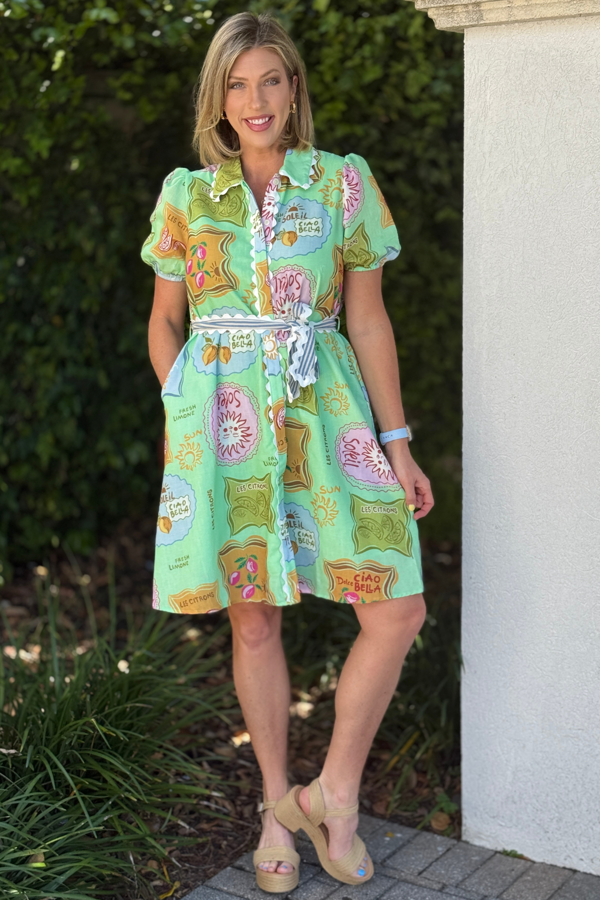 Close look at button-down summer dress with travel-inspired graphic print