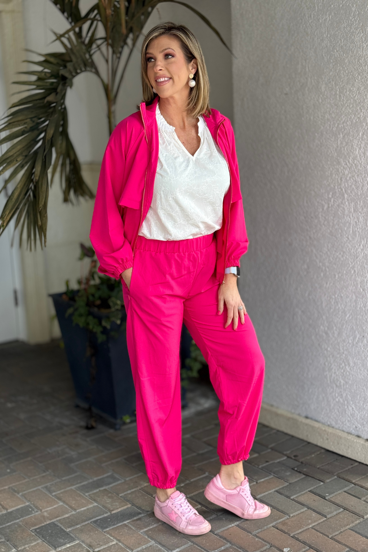 Bright coral two piece lounge set with jogger pants and lightweight jacket