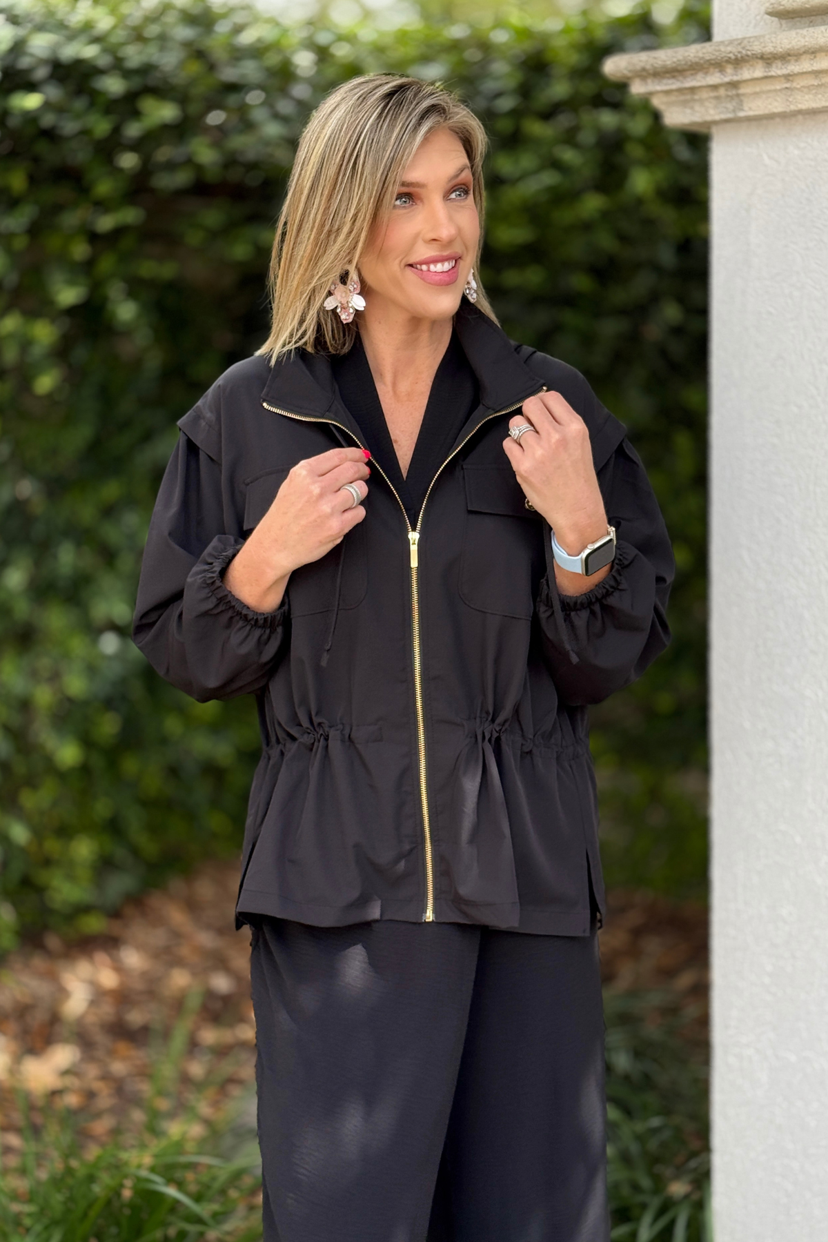 Women’s black zip-up jacket with hood and relaxed A-line silhouette