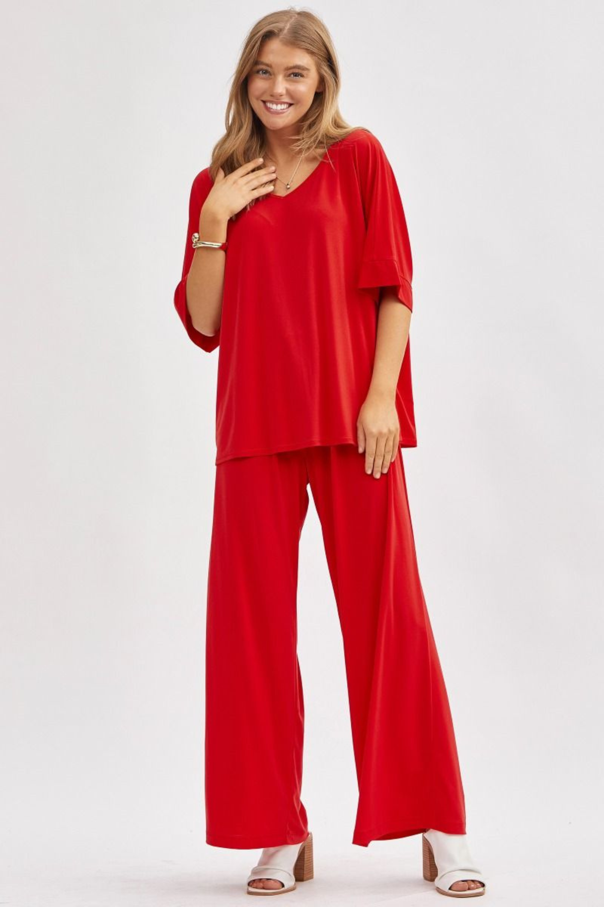 Woman wearing The Cabana Lounge Set in red with a flowy dolman top and wide-leg pants from The Pink Nickel.
