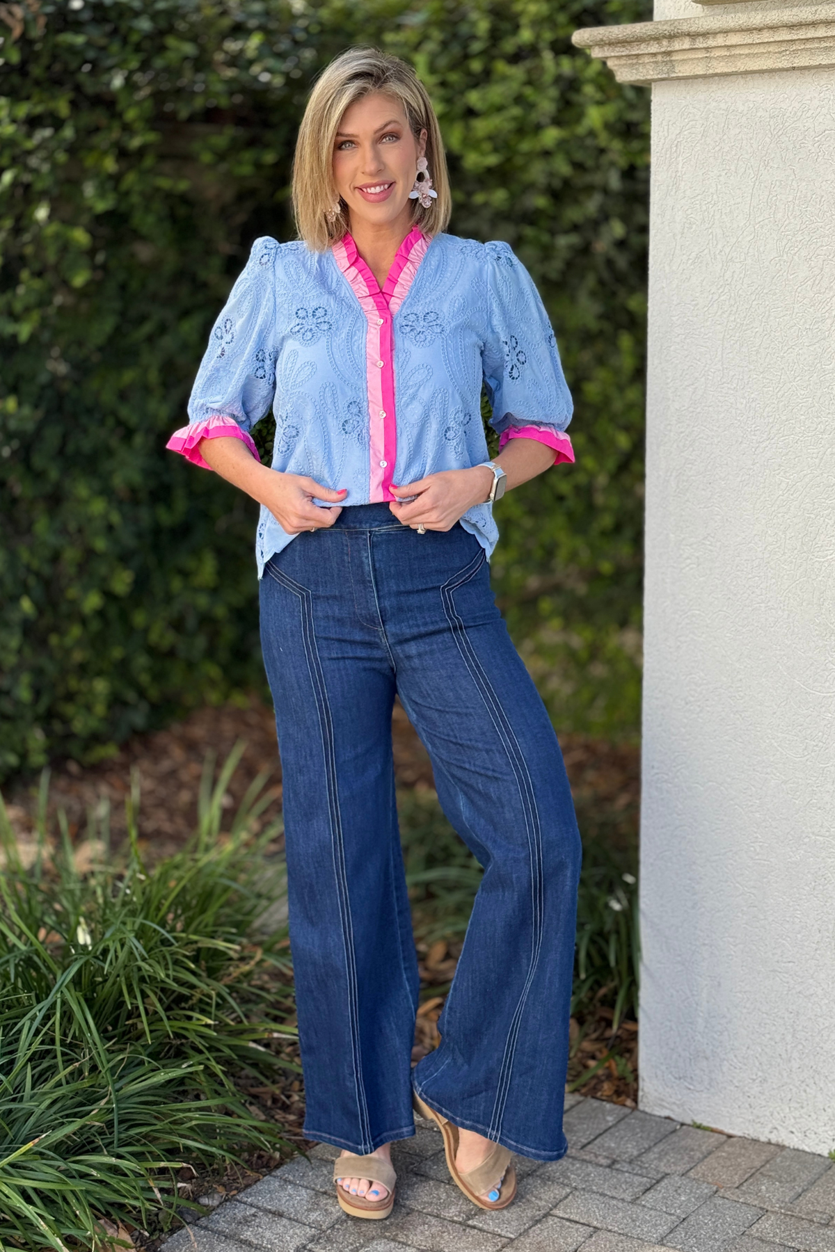 Flattering dark blue wide leg jeans styled with heels