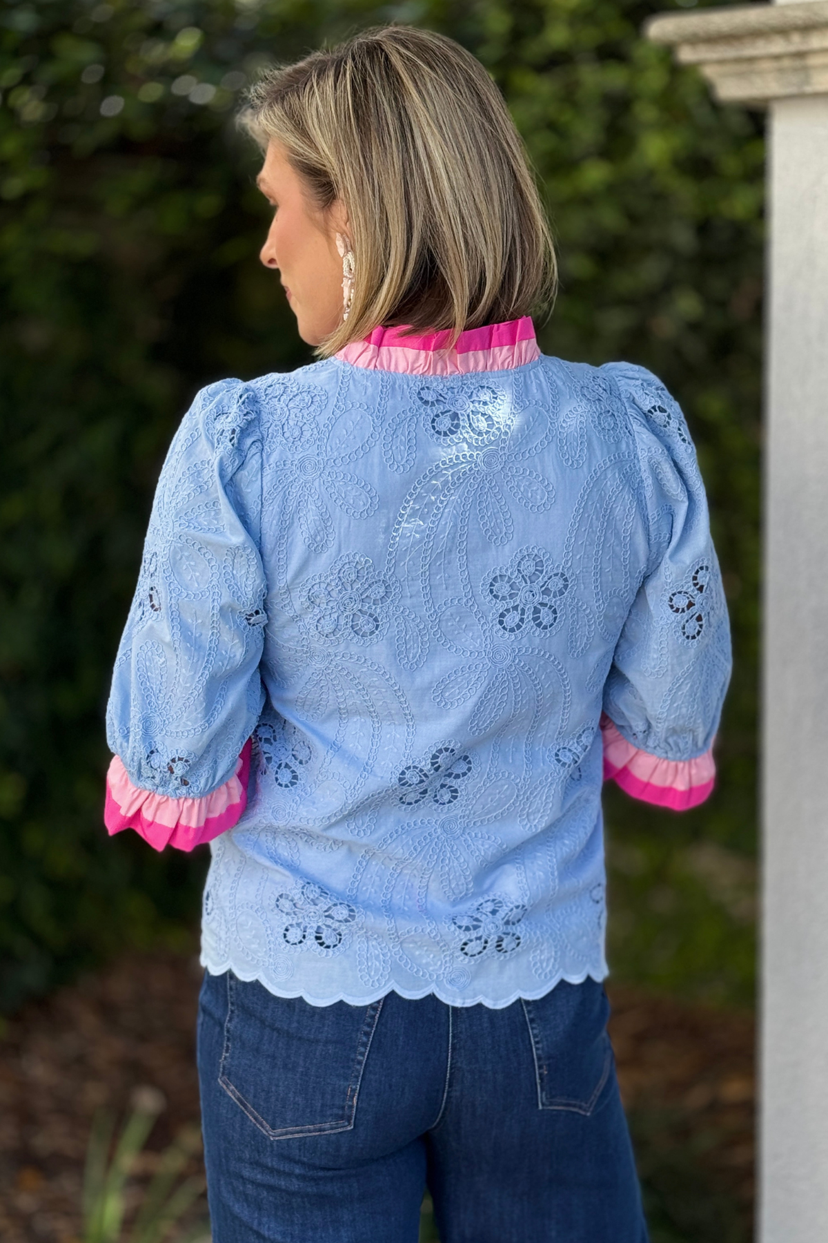 Boutique blue eyelet blouse with bold pink placket detail