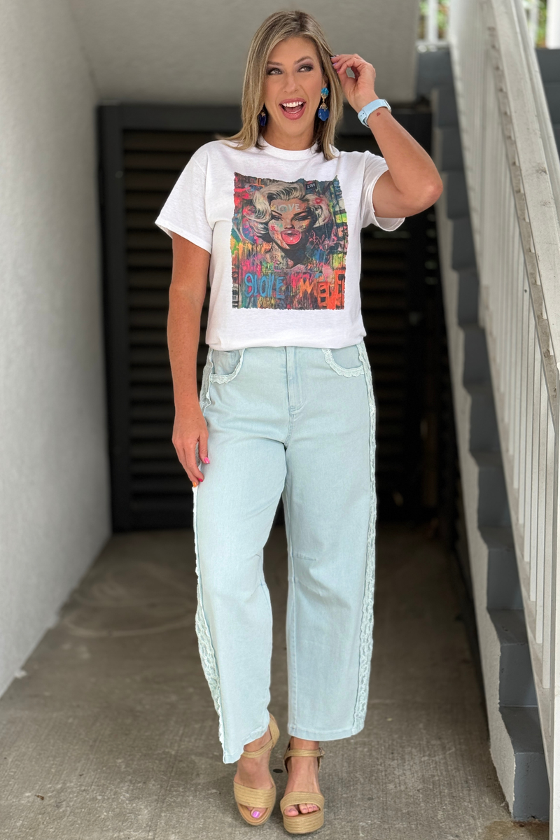 Women's light wash denim pants with lace panels