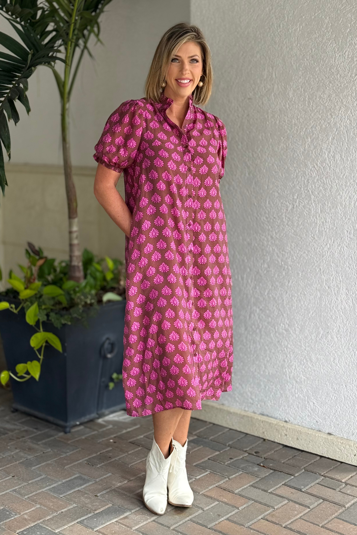 Brown and pink relaxed-fit midi dress styled with white boots