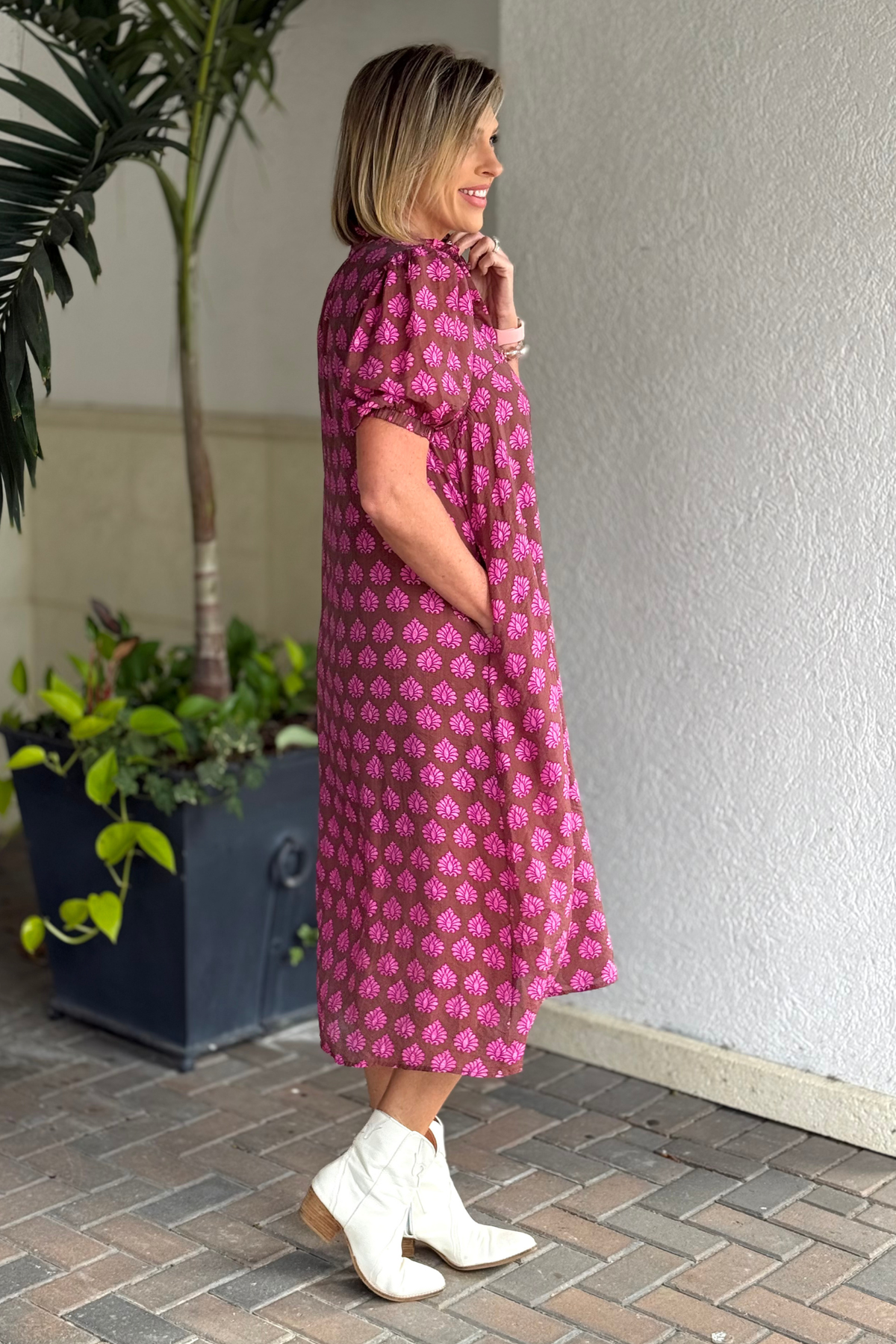 Close-up of printed button-down midi dress with elastic sleeves