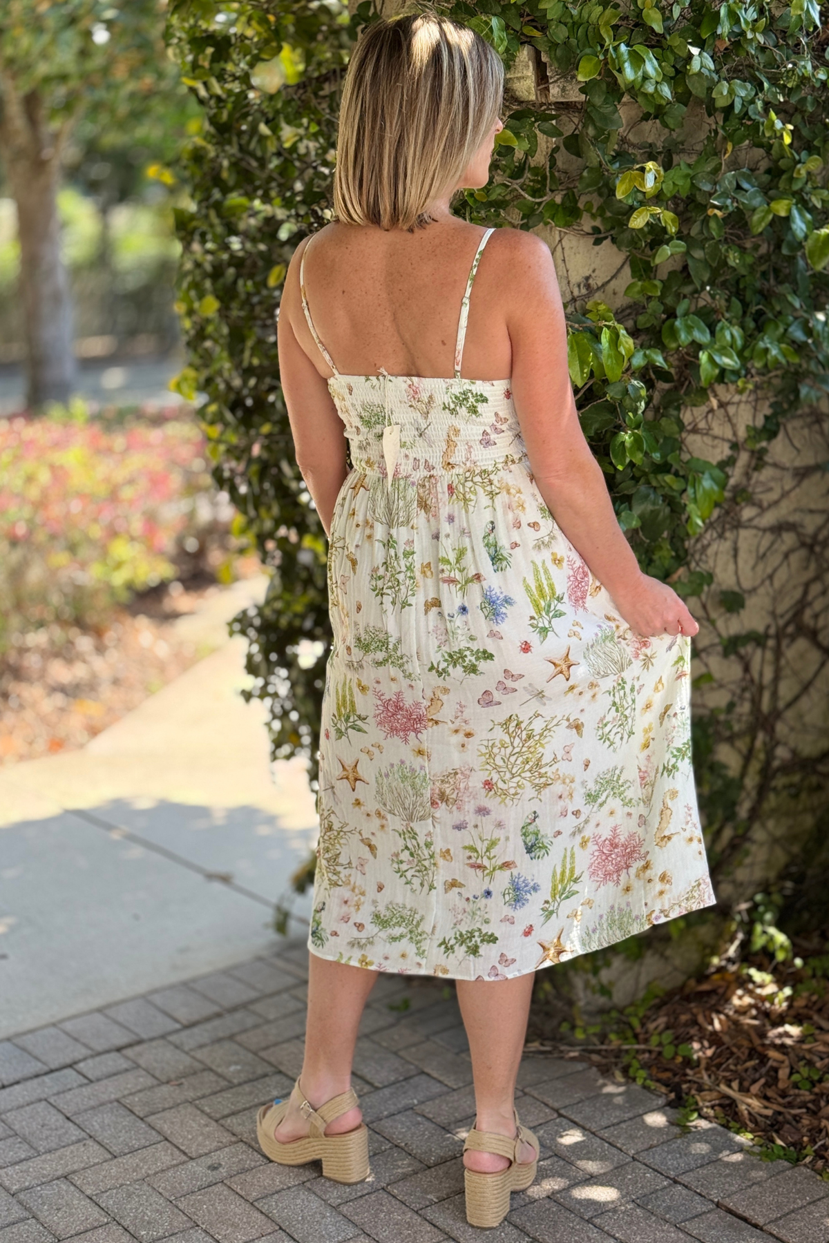 Adjustable strap smocked dress styled with wedge sandals