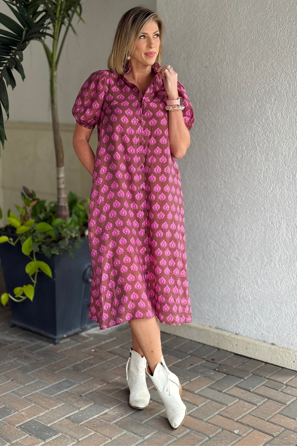 Woman wearing brown and pink printed button-down midi dress
