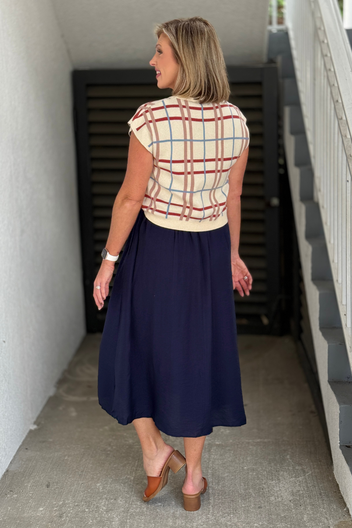 Removable cream plaid knit pullover styled over navy midi dress