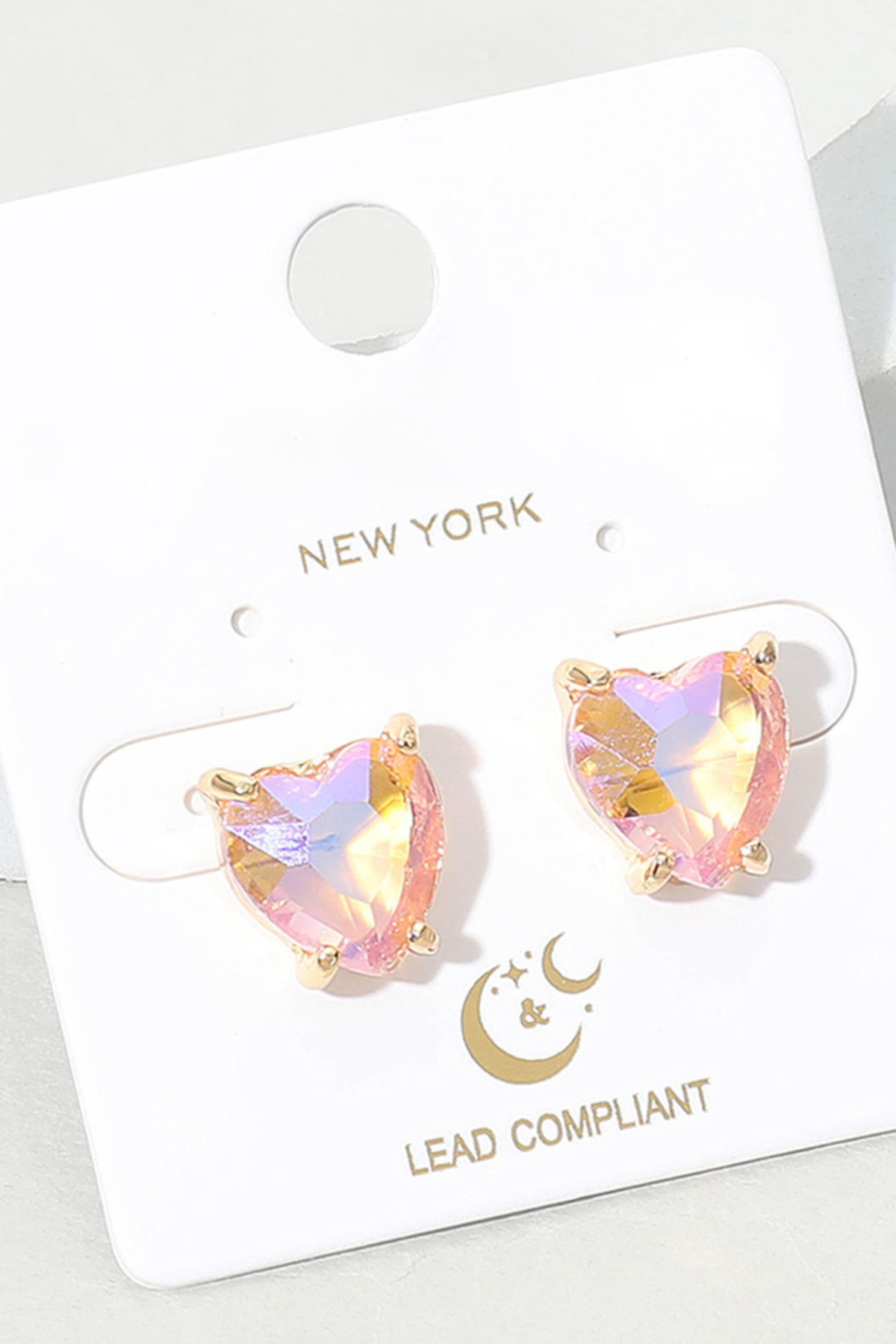 Light pink faceted heart stud earrings with gold prong setting