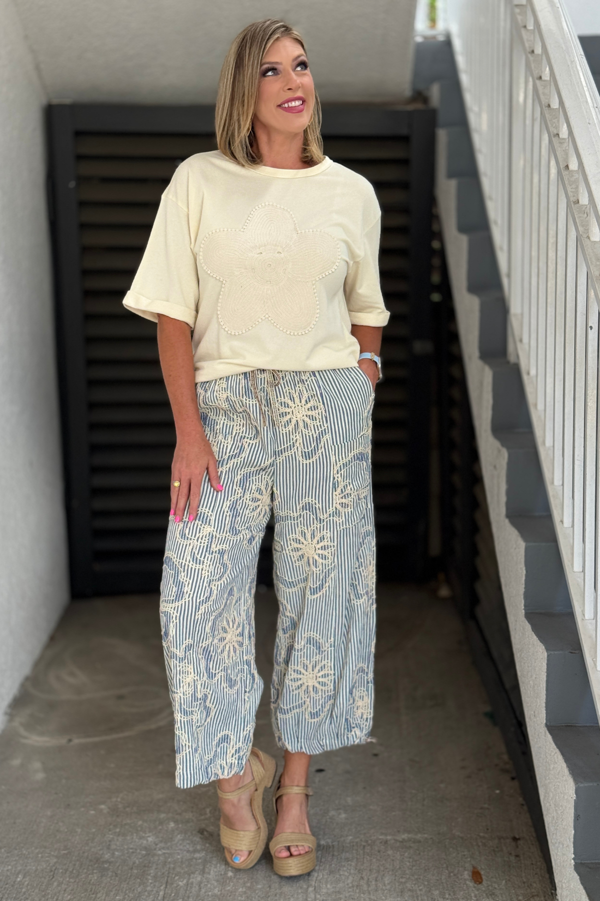 Soft cream terry knit top paired with embroidered striped pants