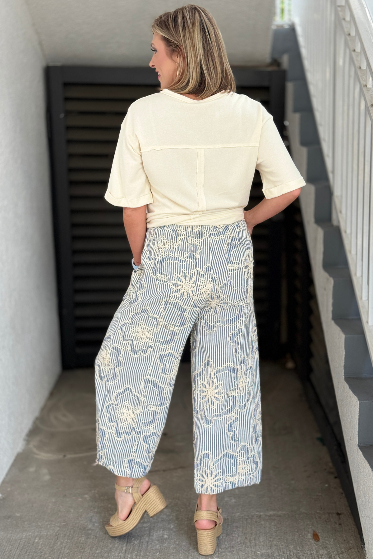 Blue and ivory embroidered striped pants styled with neutral summer top