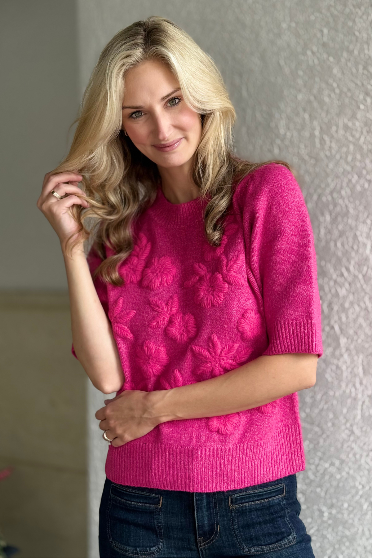 Short puff sleeve pink sweater styled with jeans