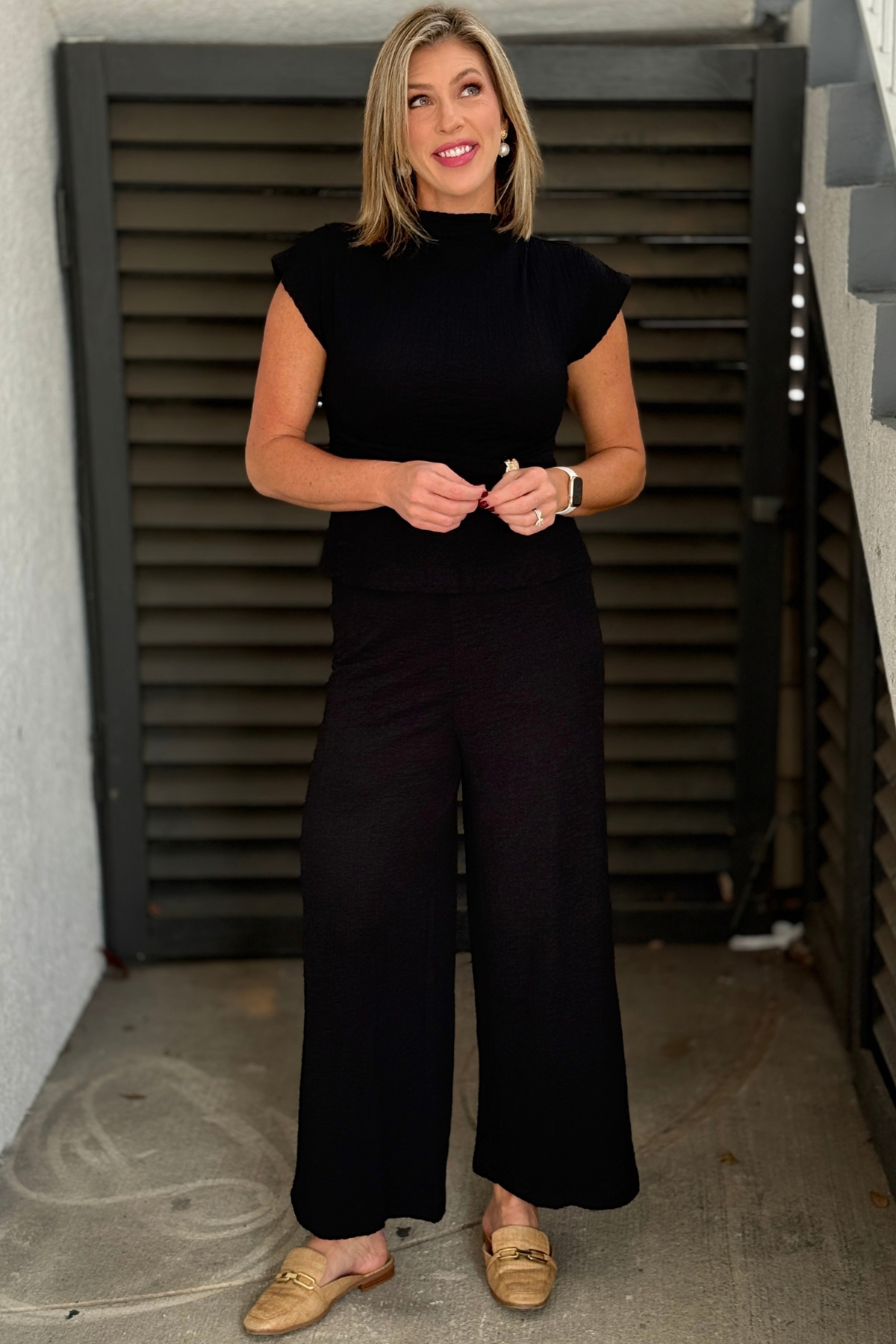 Black fitted mock neck top with flowy pants