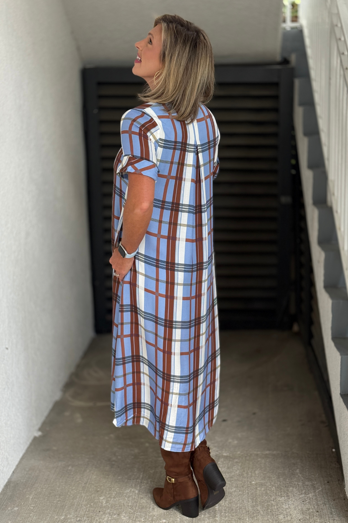 Plaid midi dress styled with tall brown boots
