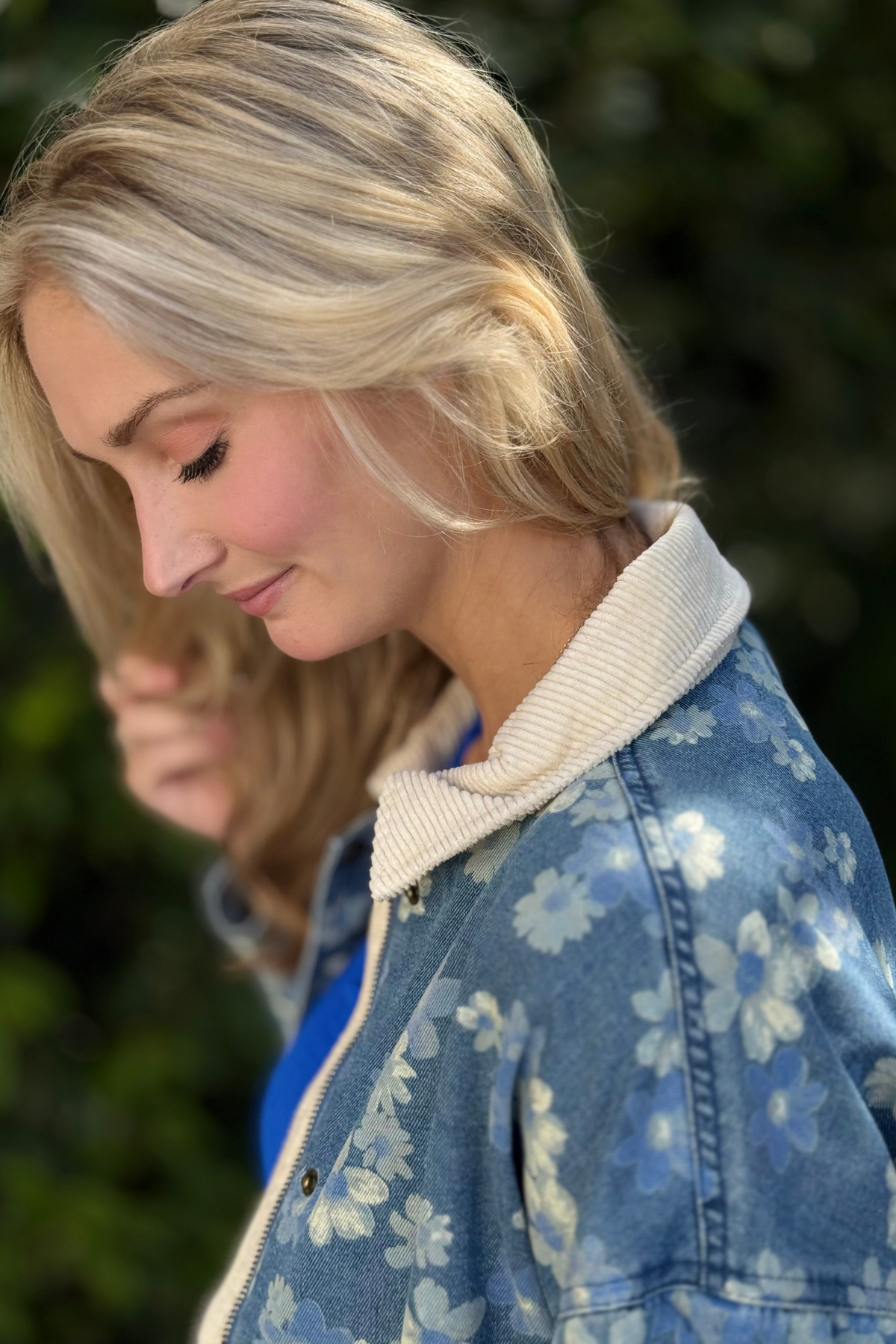 Close-up of corduroy collar on blue floral denim jacket