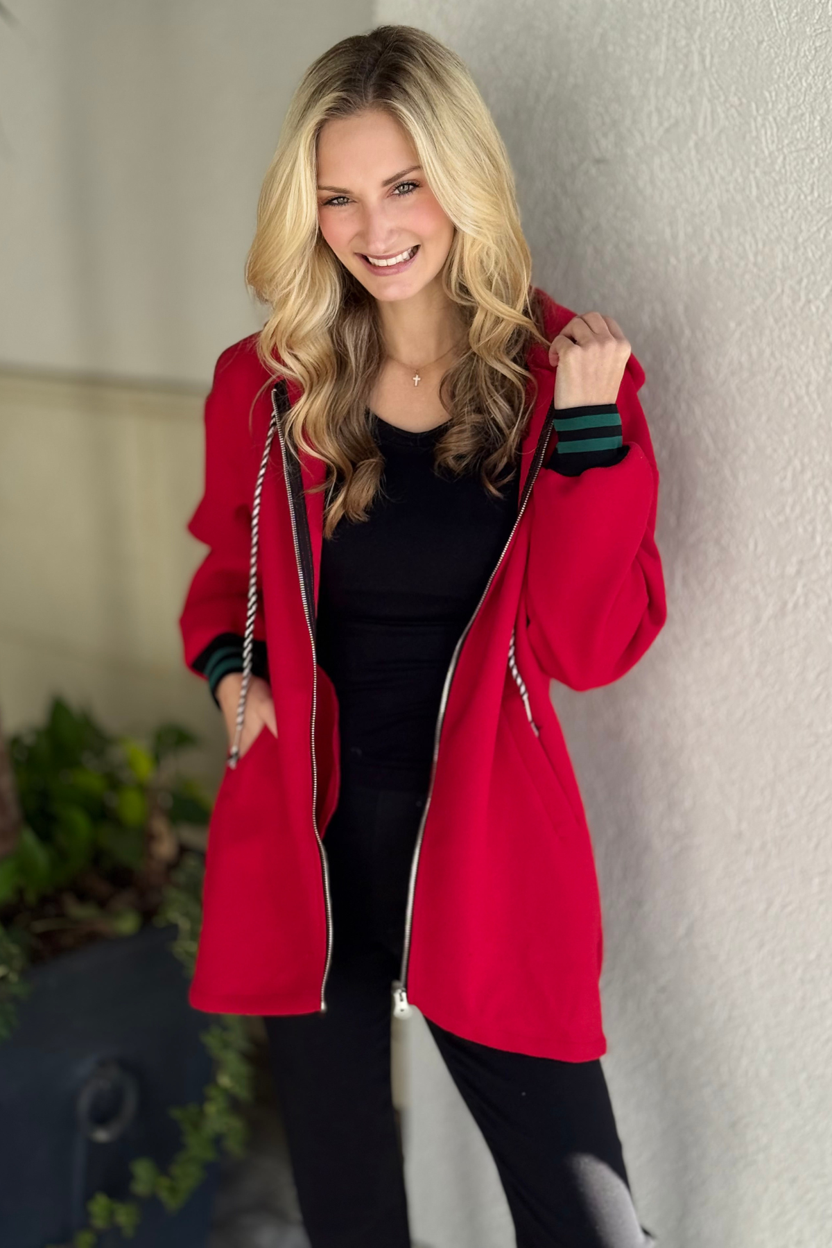 Red zip hoodie with contrast green and black cuffs