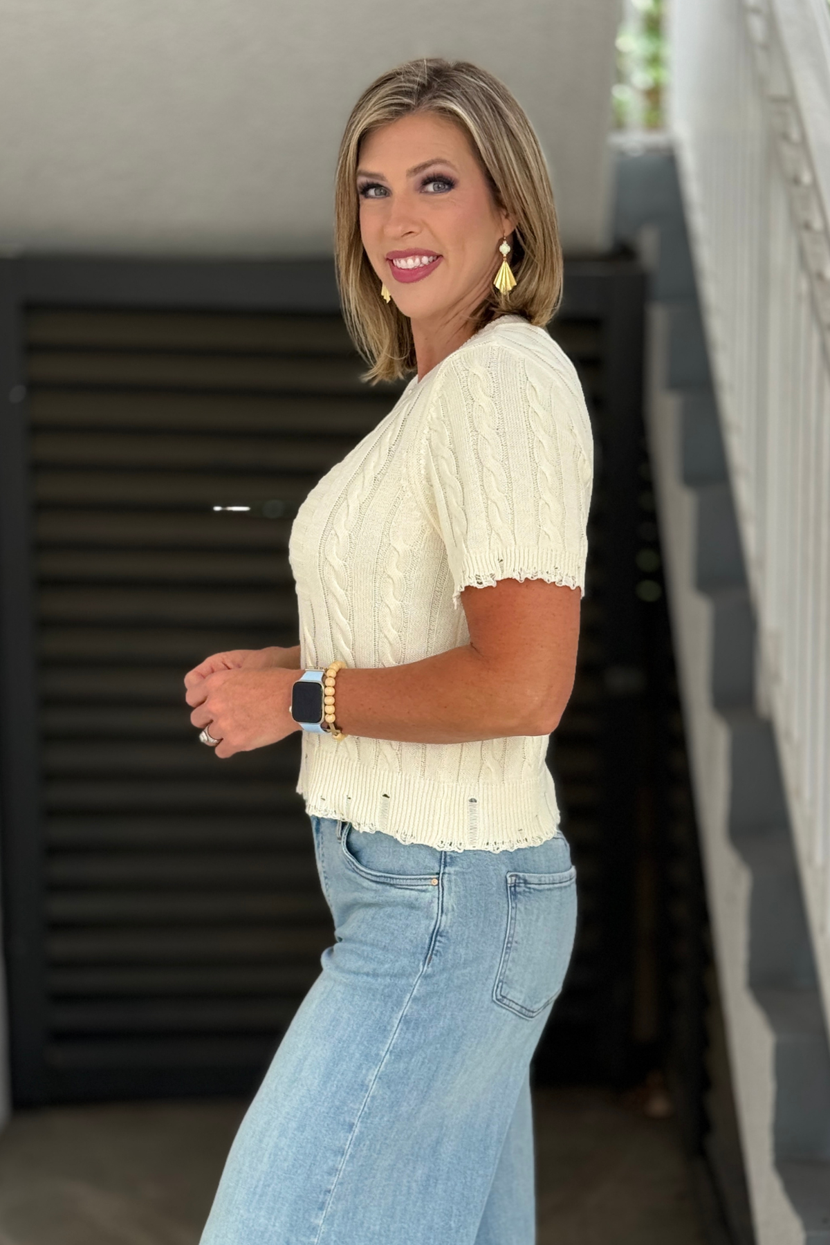 Ecru cable knit sweater tee with distressed hem detail