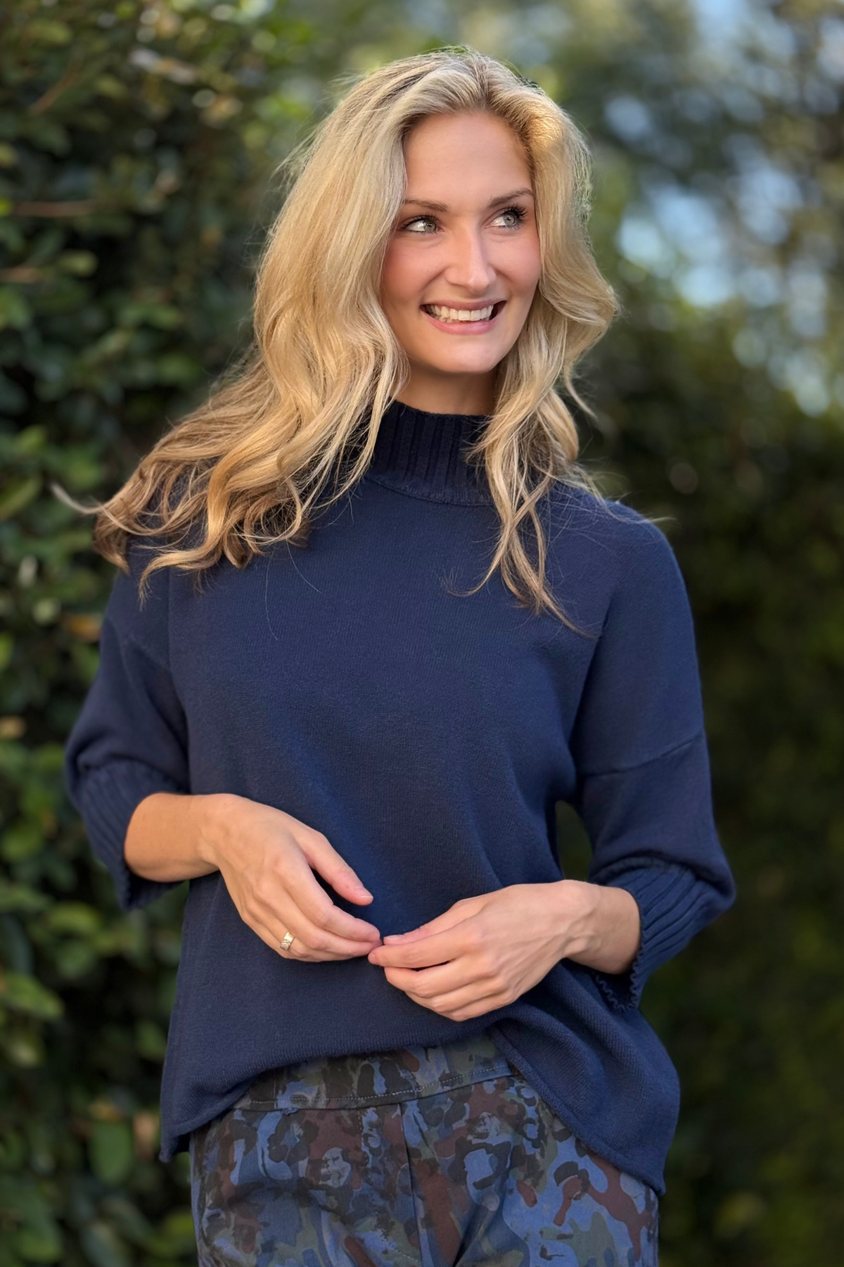 Flora Ashley Mock Neck Knit Sweater in navy styled with printed pants