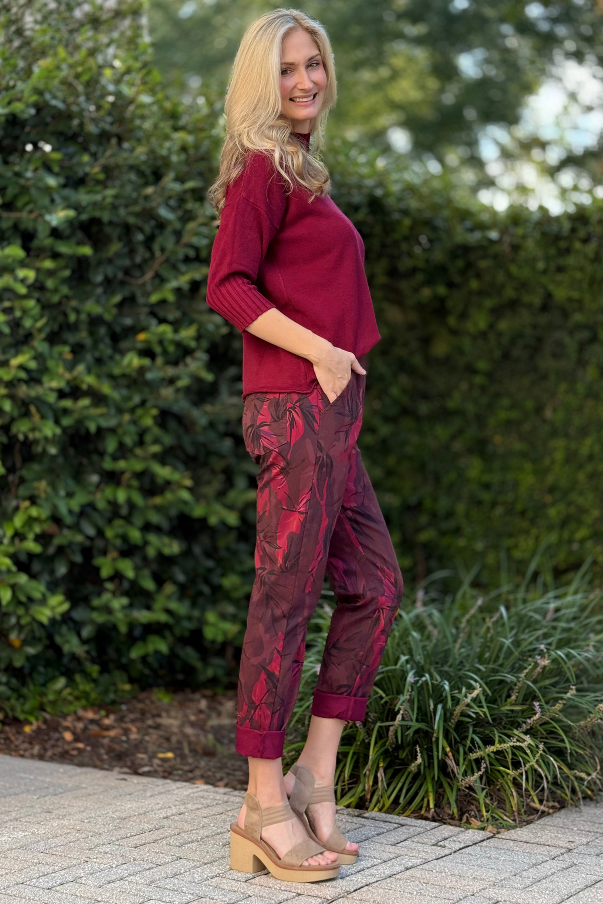 Side angle of Flora Ashley burgundy printed pants showing relaxed fit