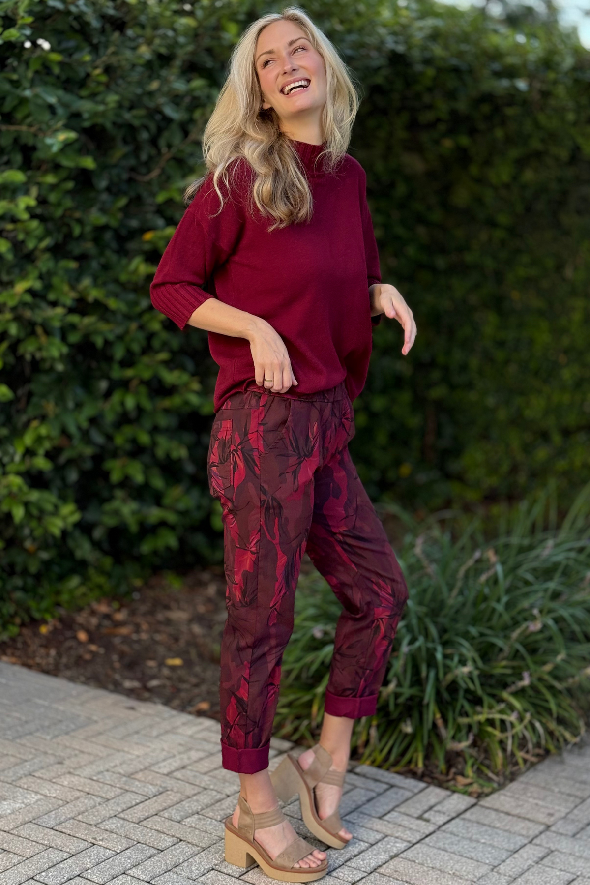 Front view of model wearing Flora Ashley Pull-On Printed Pants in burgundy floral print