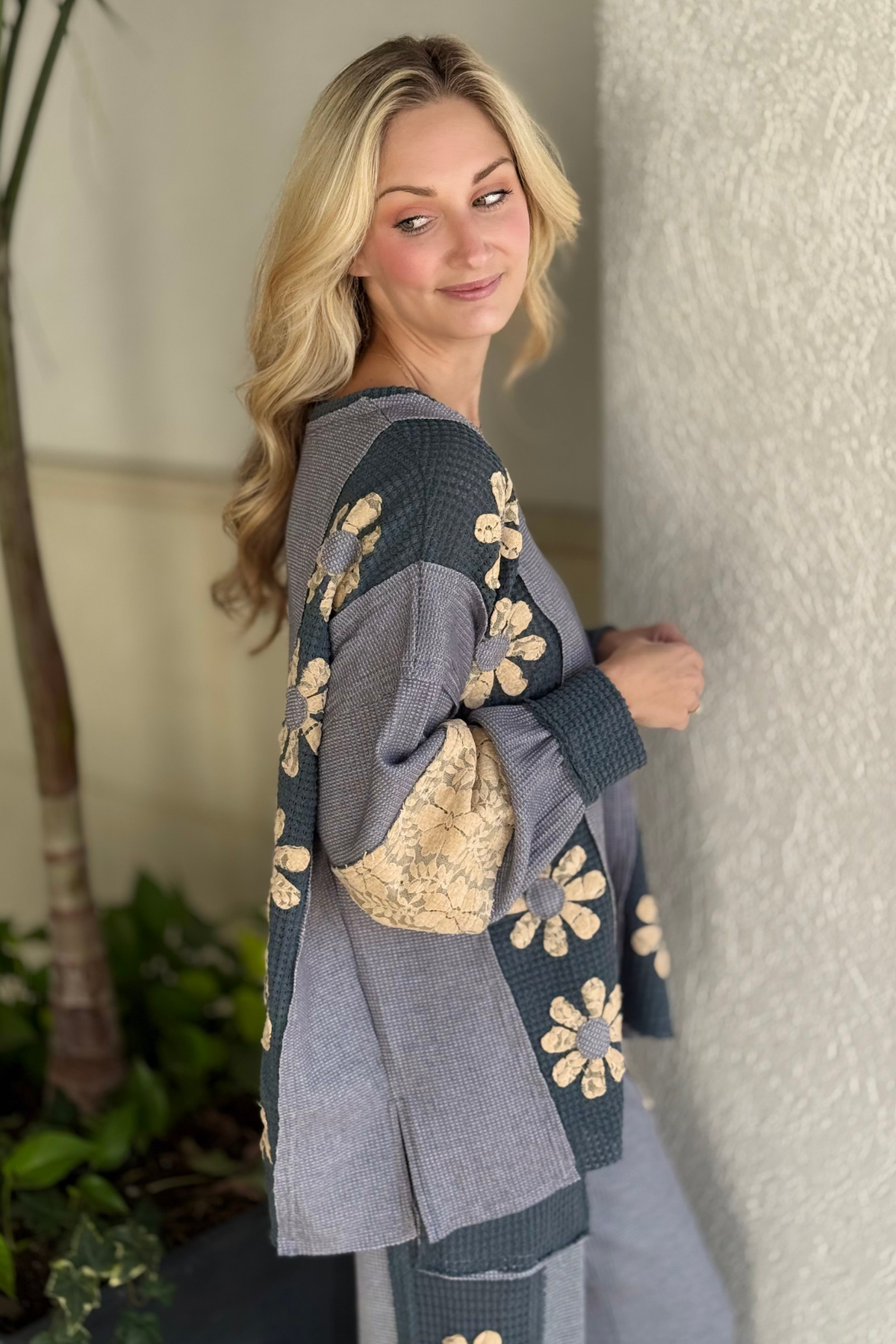 Textured waffle knit top with floral lace sleeves