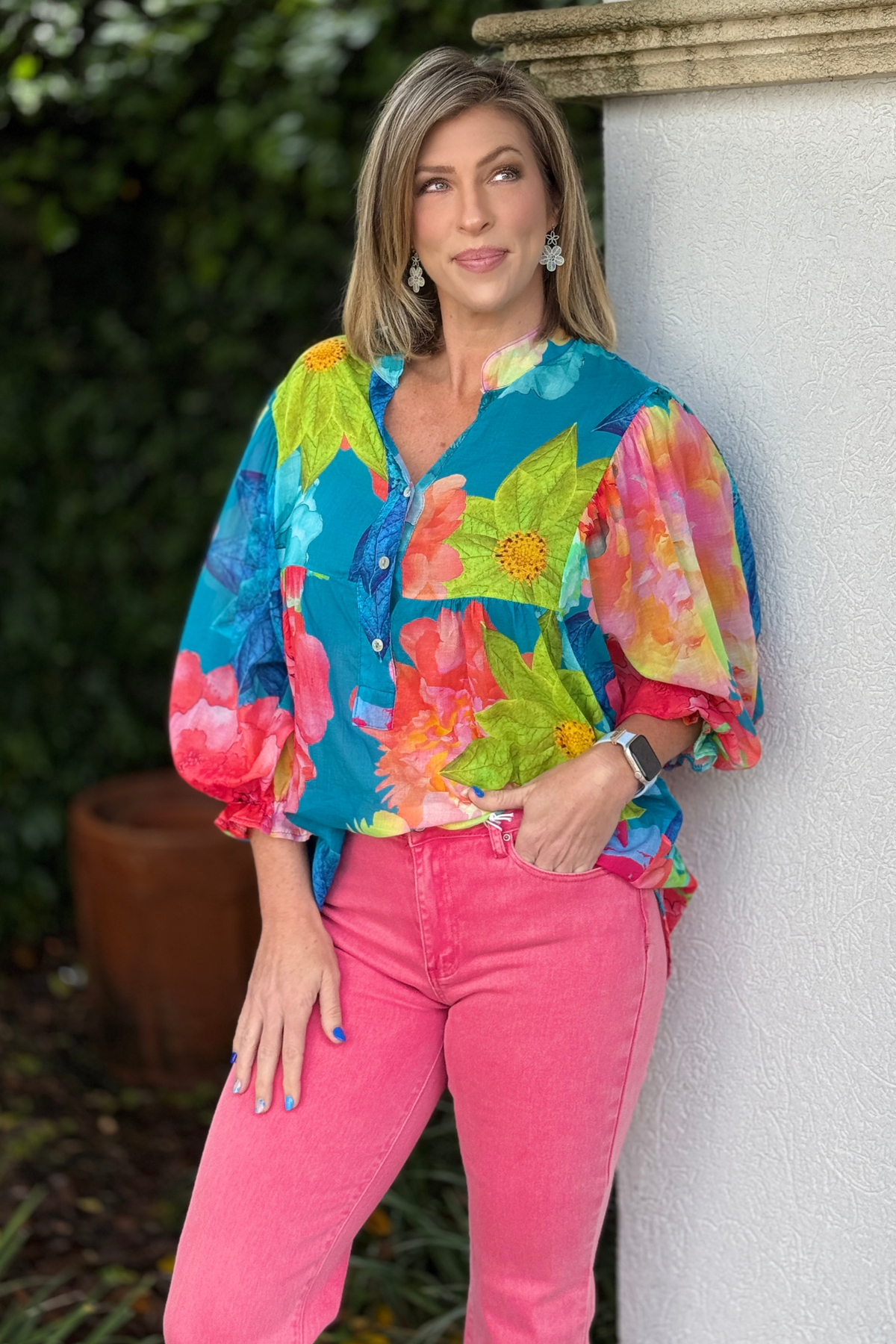 Statement floral blouse paired with pink denim and wedges