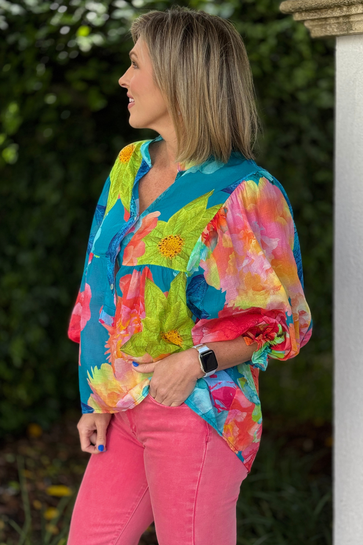 Close up of vibrant floral print blouse with button detail neckline