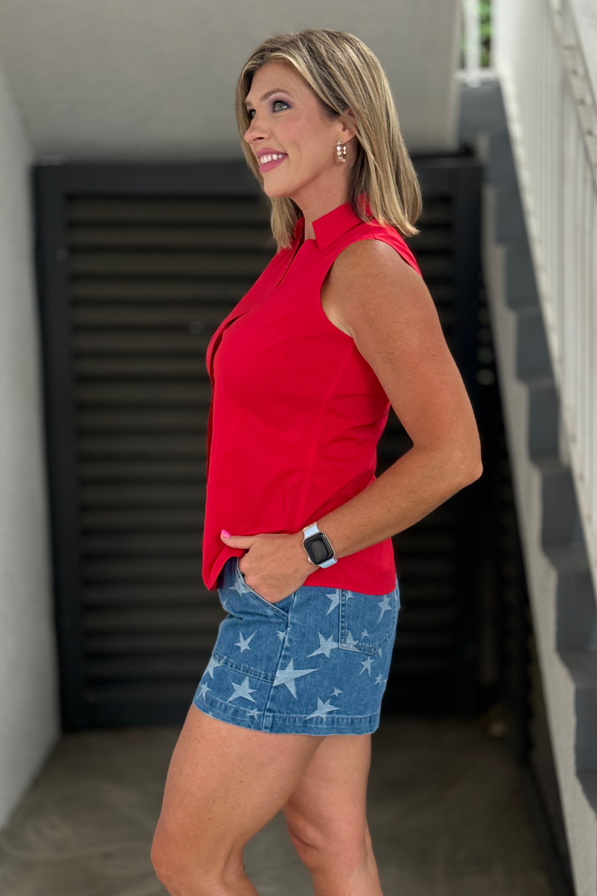 Bright red non-iron blouse styled with denim shorts