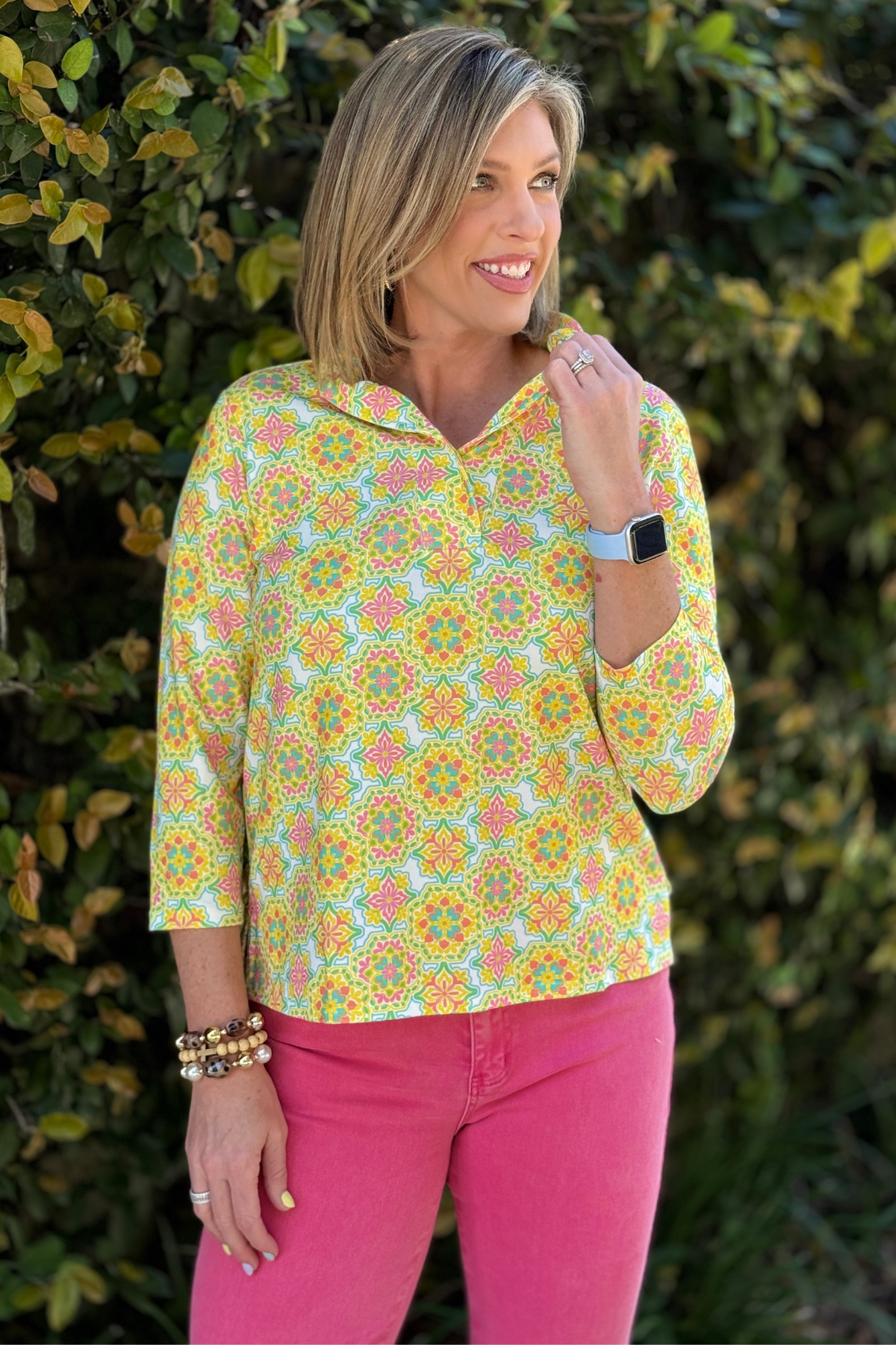 bright patterned top with 3/4 sleeves styled with pink jeans