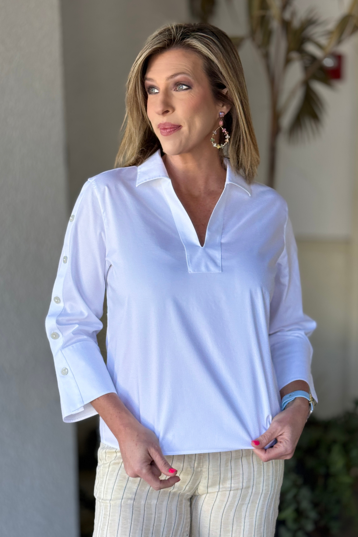 White boutique blouse styled with striped trousers