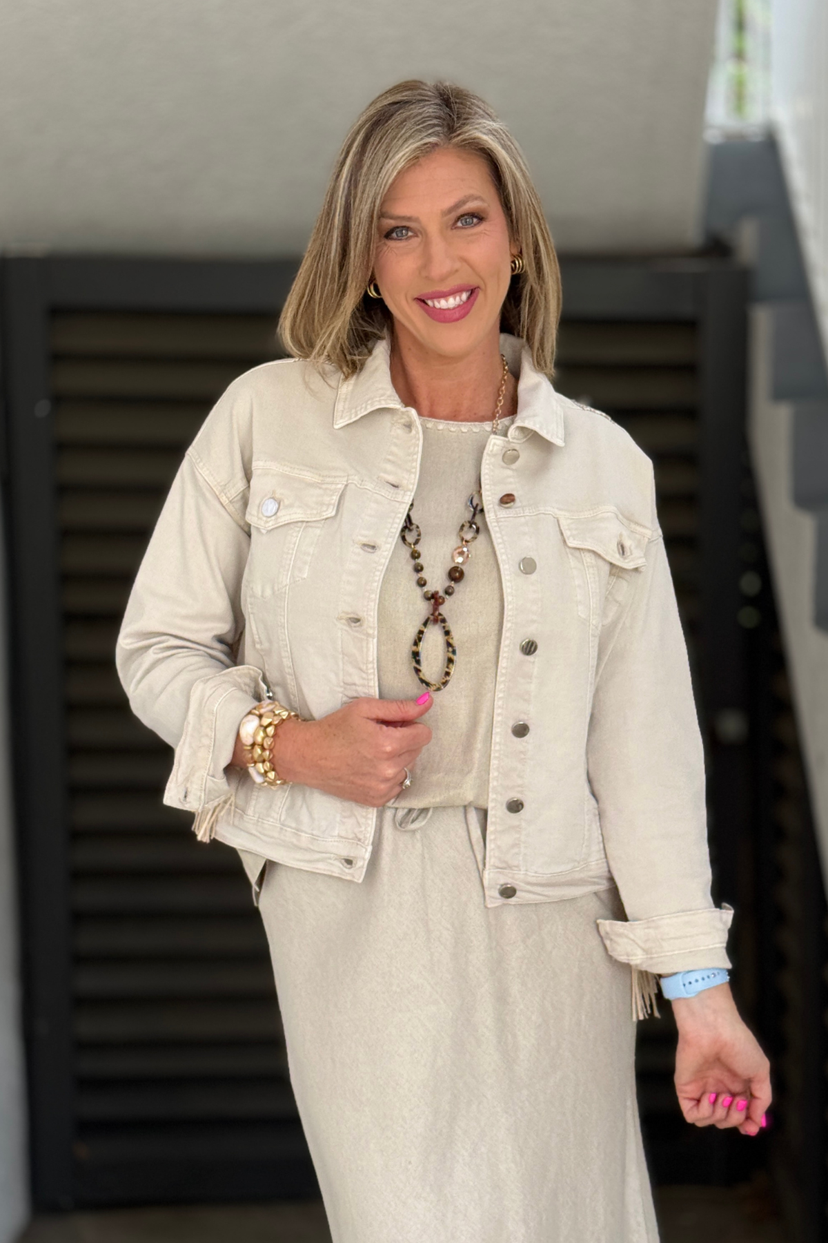 neutral denim jacket with rhinestone and fringe details