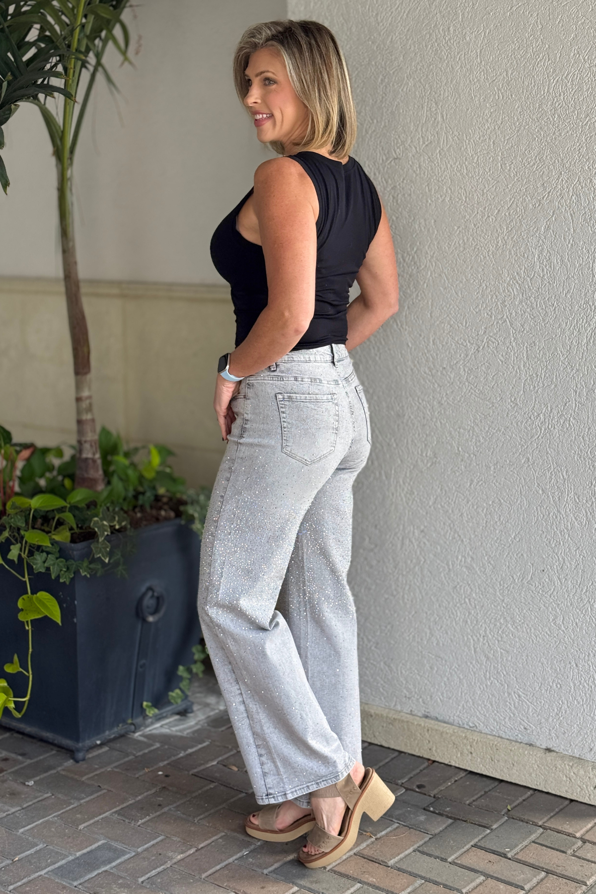 Back view of embellished bootcut jeans with pockets