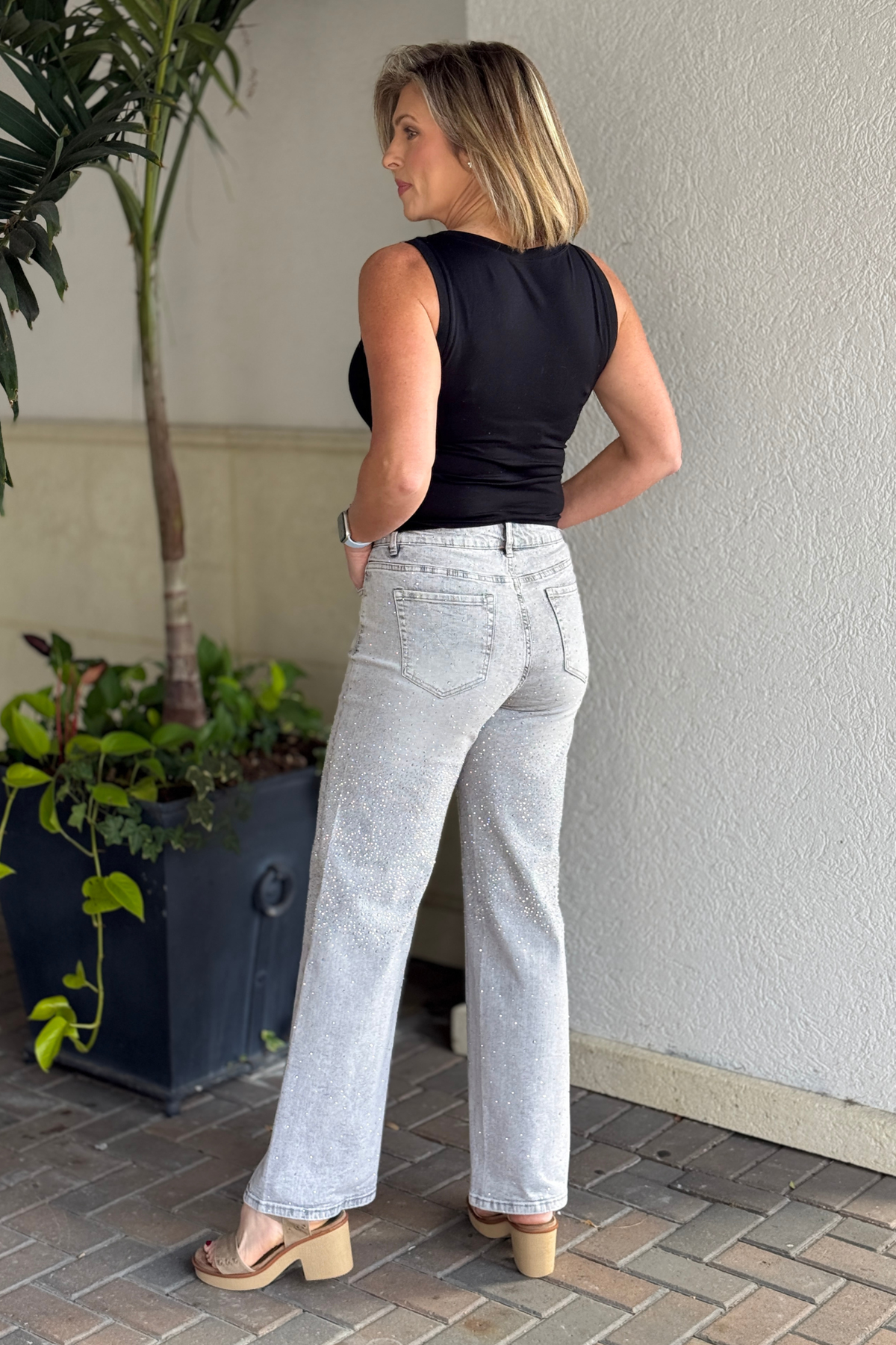 Side view of relaxed fit rhinestone denim jeans