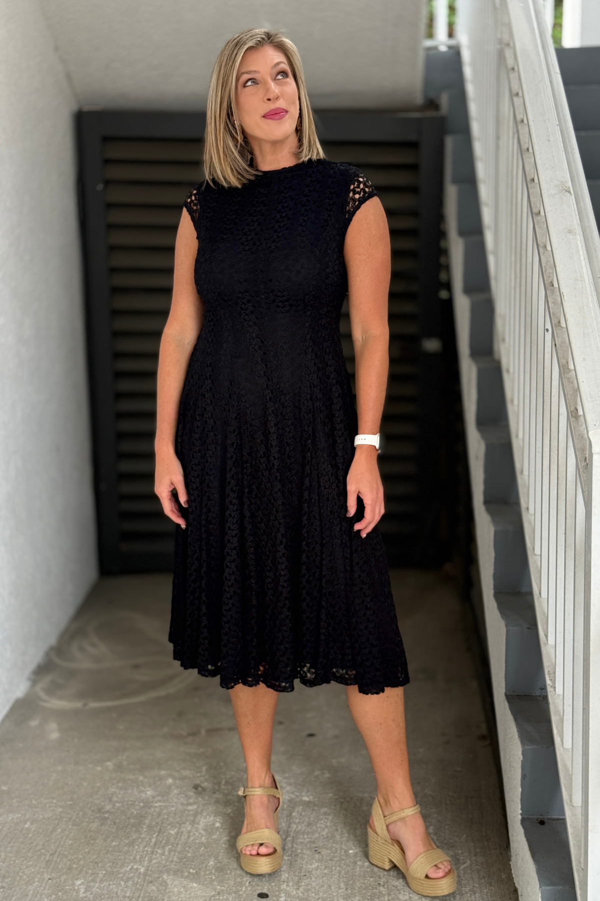 Luxury black lace A-line dress styled with statement belt and boots