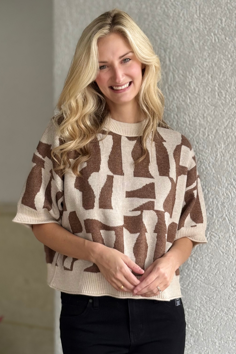 Model wearing short sleeve abstract sweater with relaxed fit