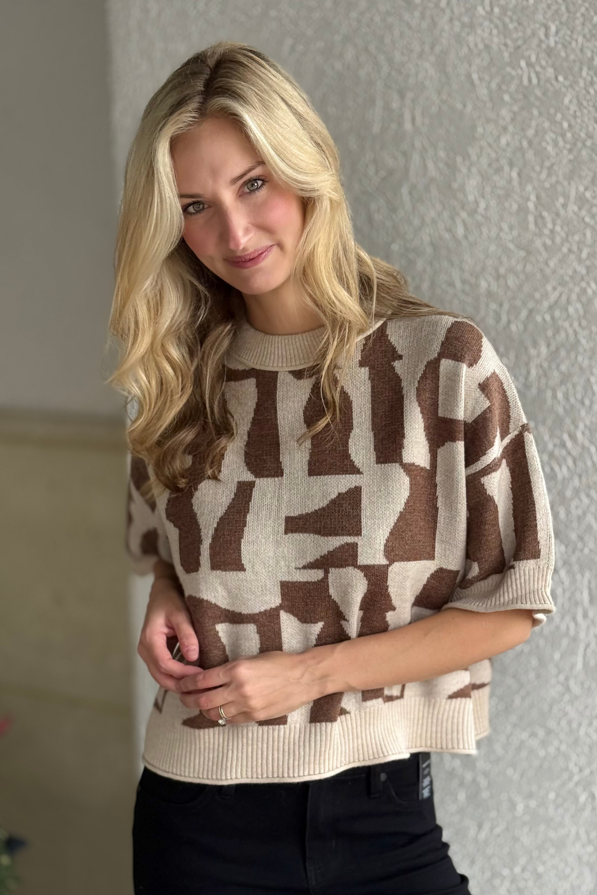 Close-up of geometric pattern and ribbed trim on sweater