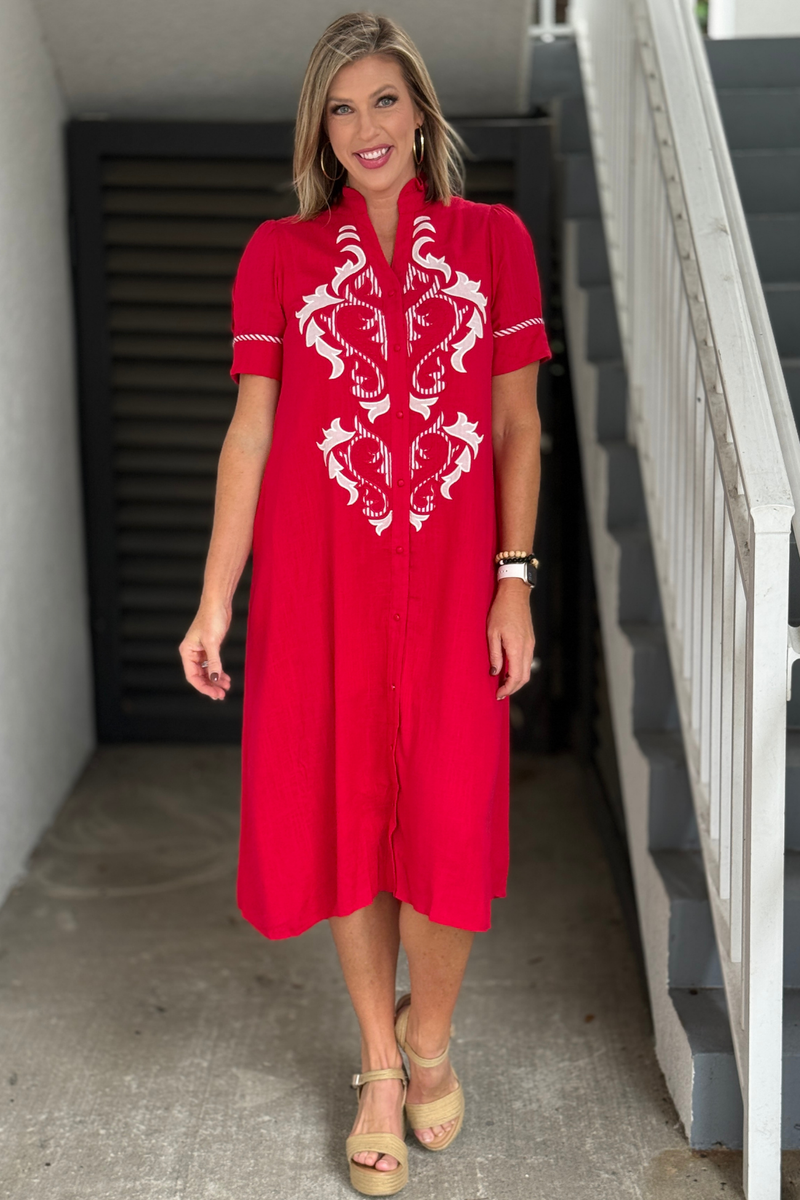 Red linen midi dress with white embroidered appliqué detailing
Women’s red button down midi dress with puff sleeves