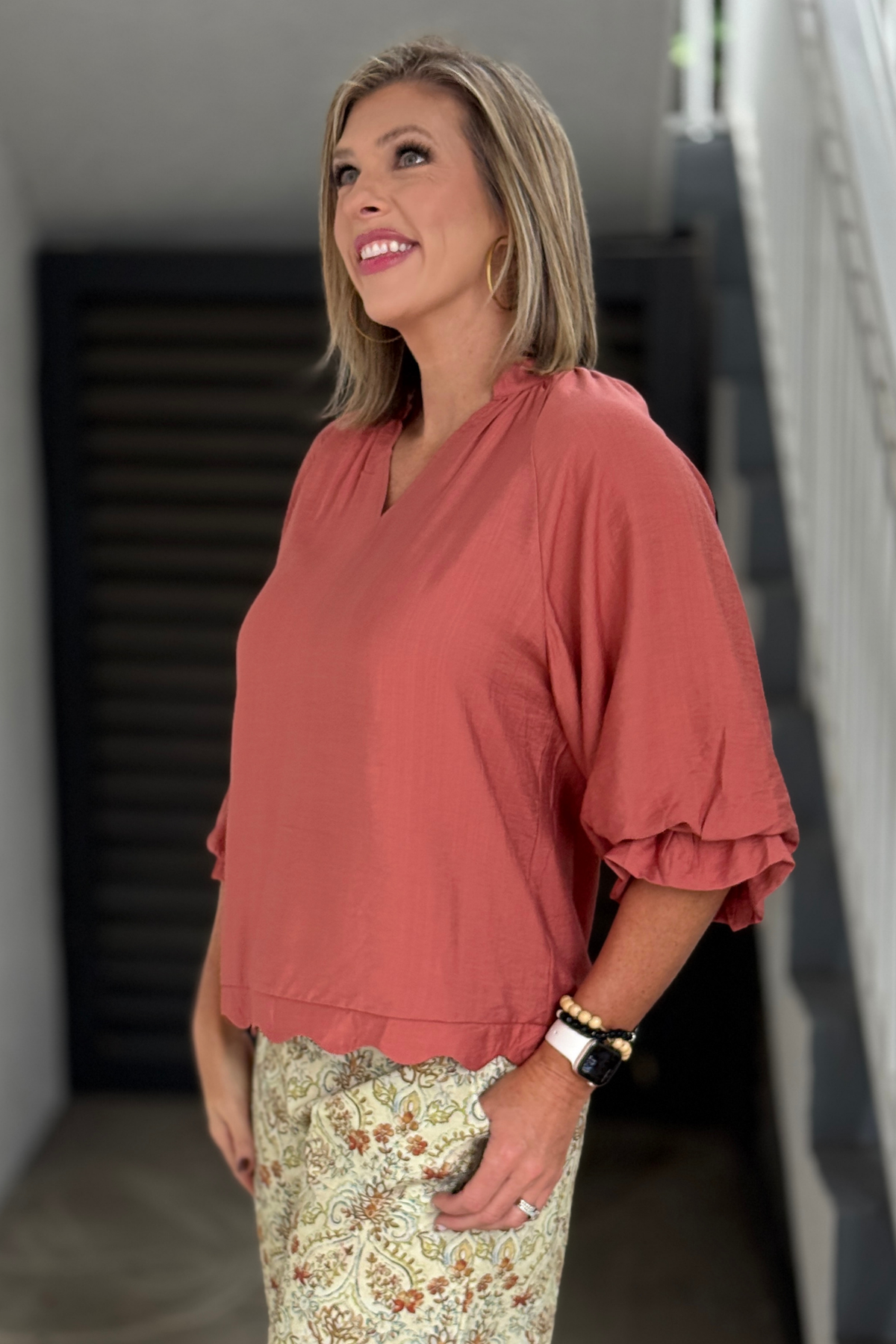 Women’s rust canyon clay V-neck blouse styled with printed pants