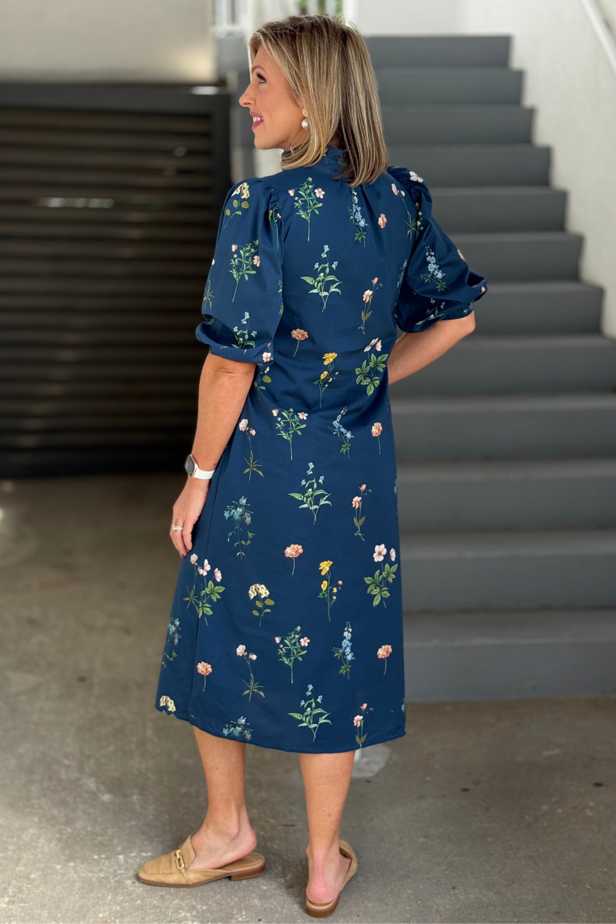 Back view of navy botanical midi dress