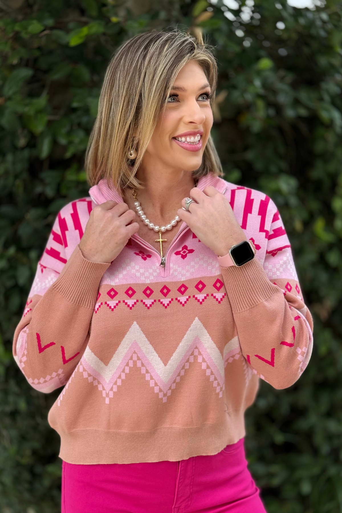 Close-up of geometric knit pink half zip pullover