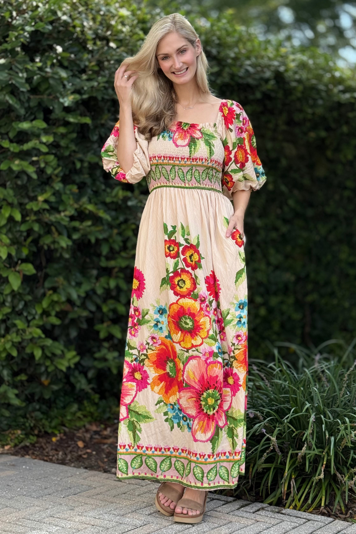 Side view highlighting bubble sleeves and flowing floral skirt