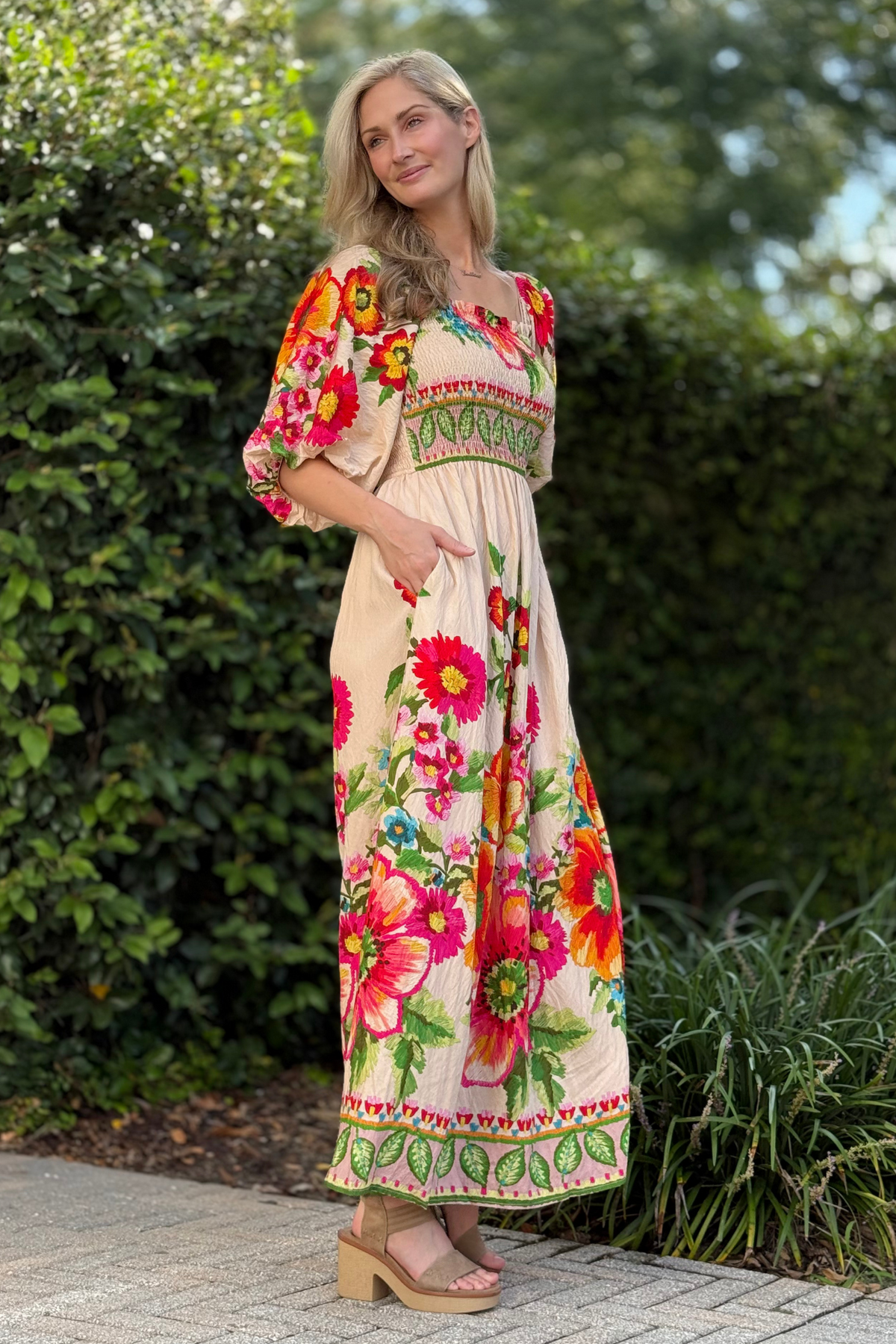Side view highlighting bubble sleeves and flowing floral skirt
