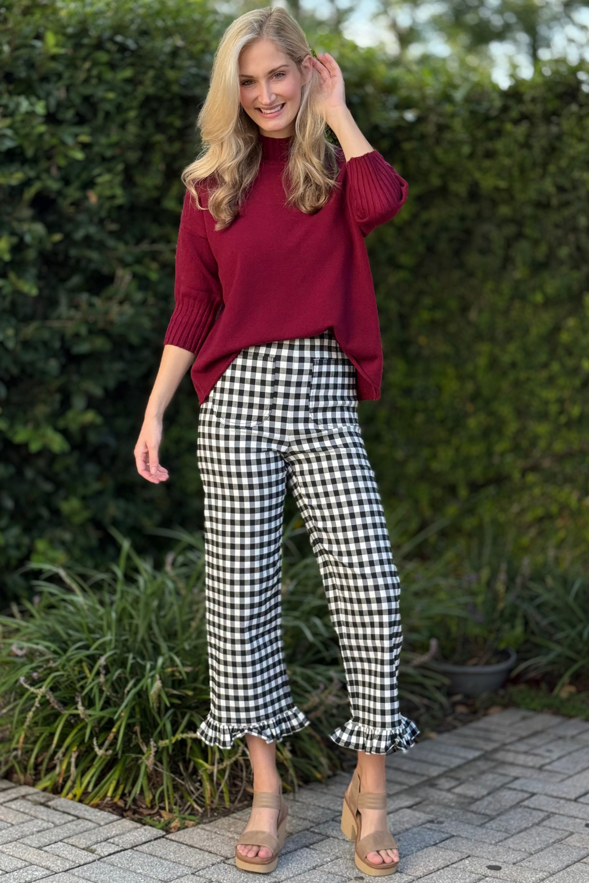 Close-up of ruffle hem detail on black-and-white gingham pants