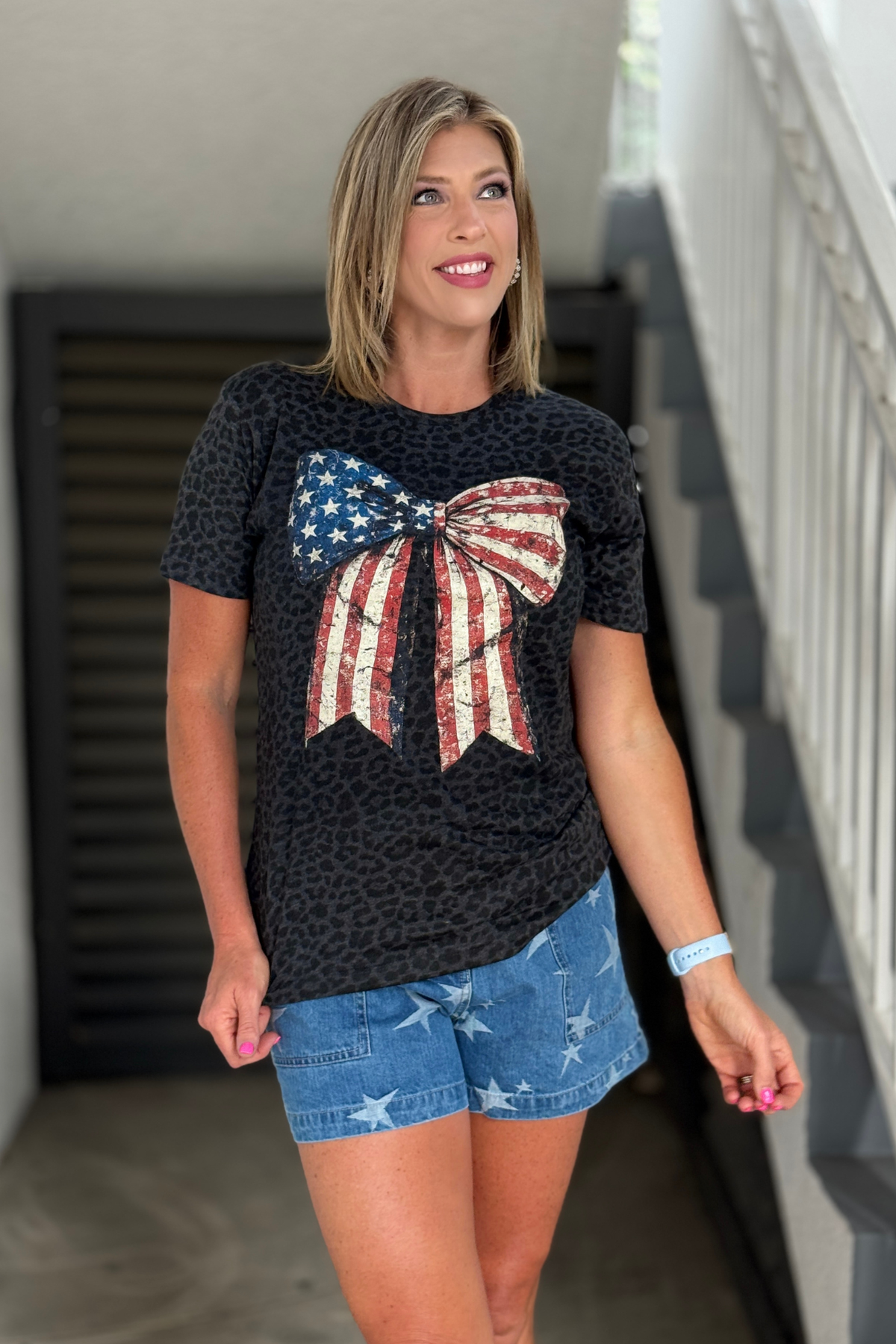 Patriotic graphic tee with American flag bow design