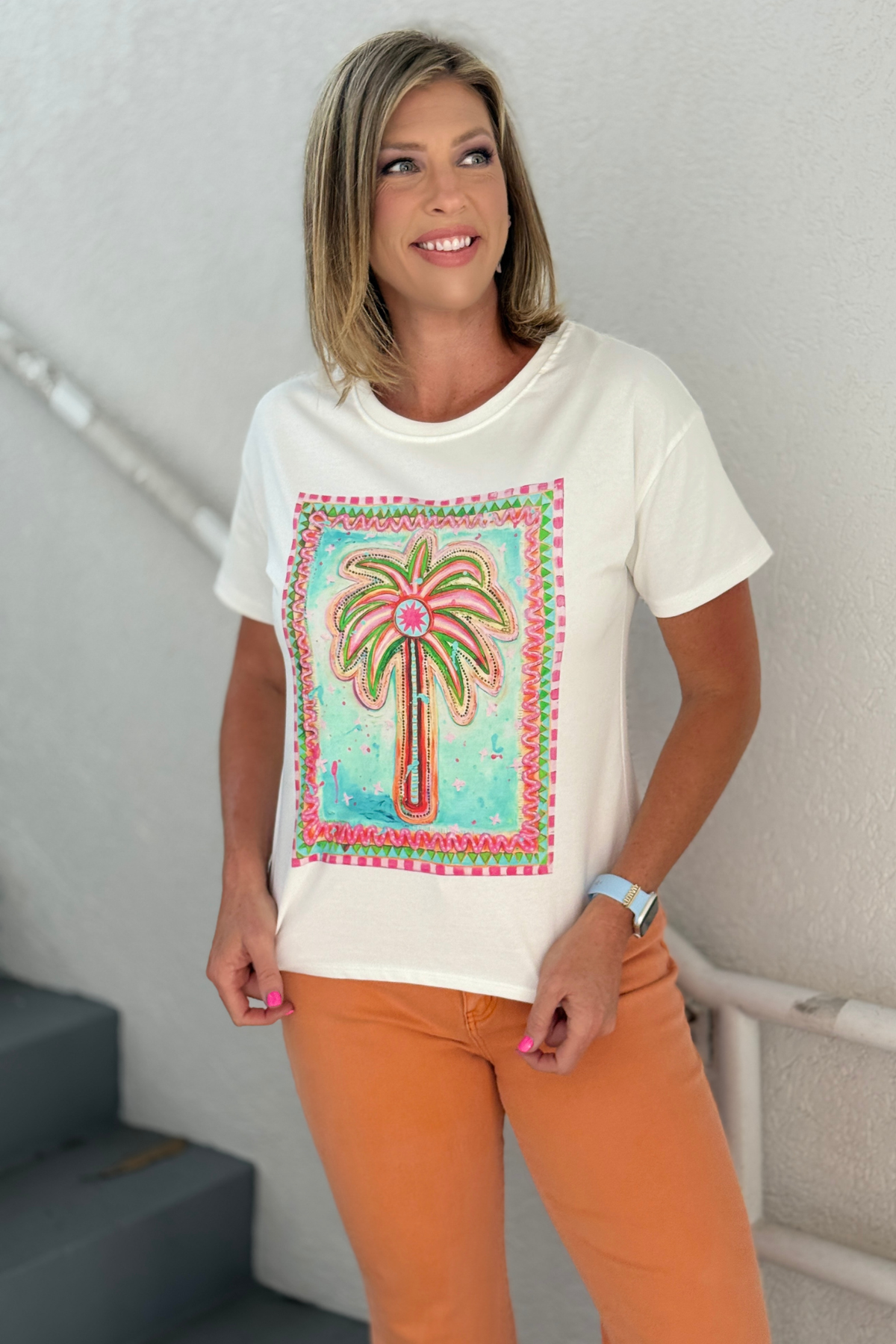 White graphic tee with colorful palm tree artwork