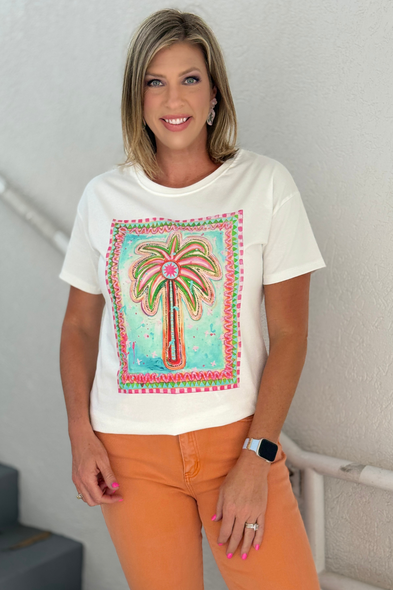 White graphic tee with colorful palm tree artwork