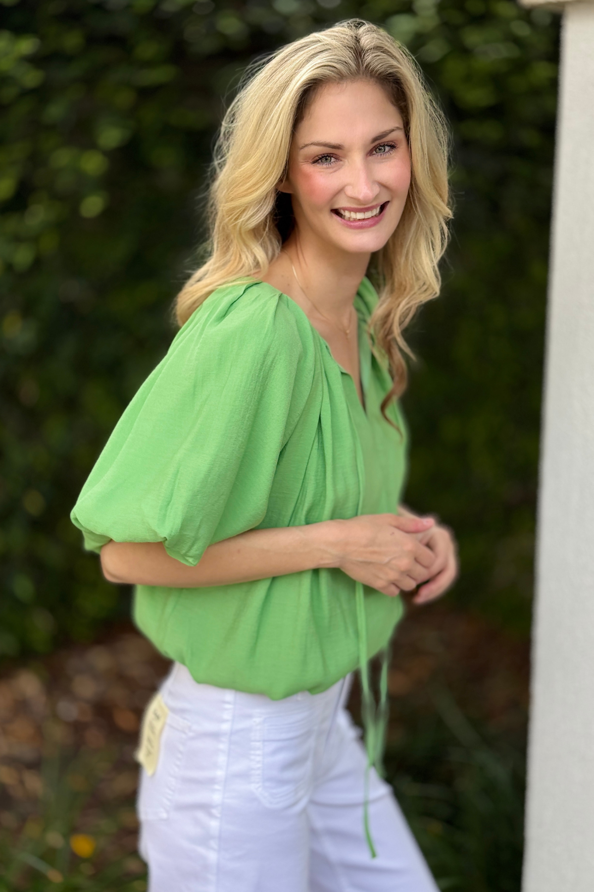 Lined green blouse styled with white pants