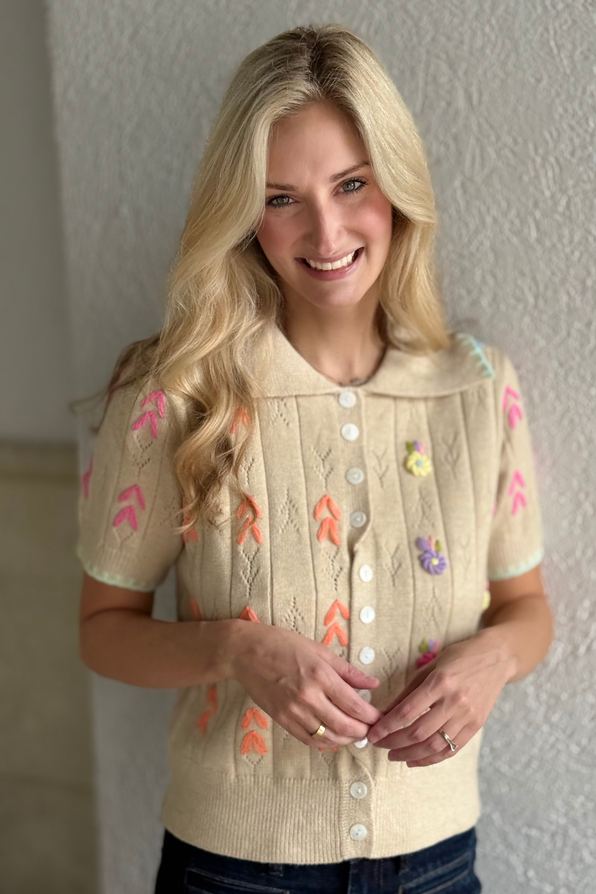 Close-up of embroidered collar and buttons on The Meadow Stitch Sweater