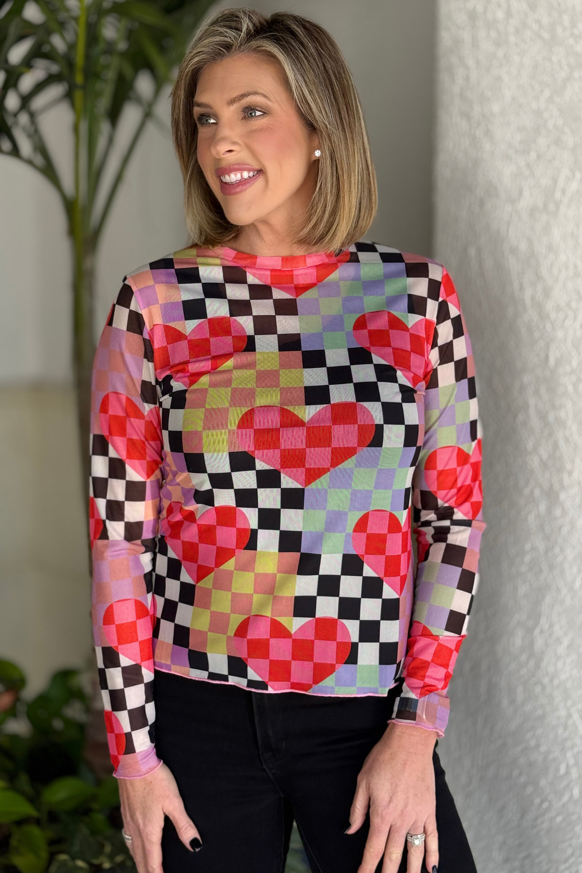 front view of checkered heart print mesh layering top on model
